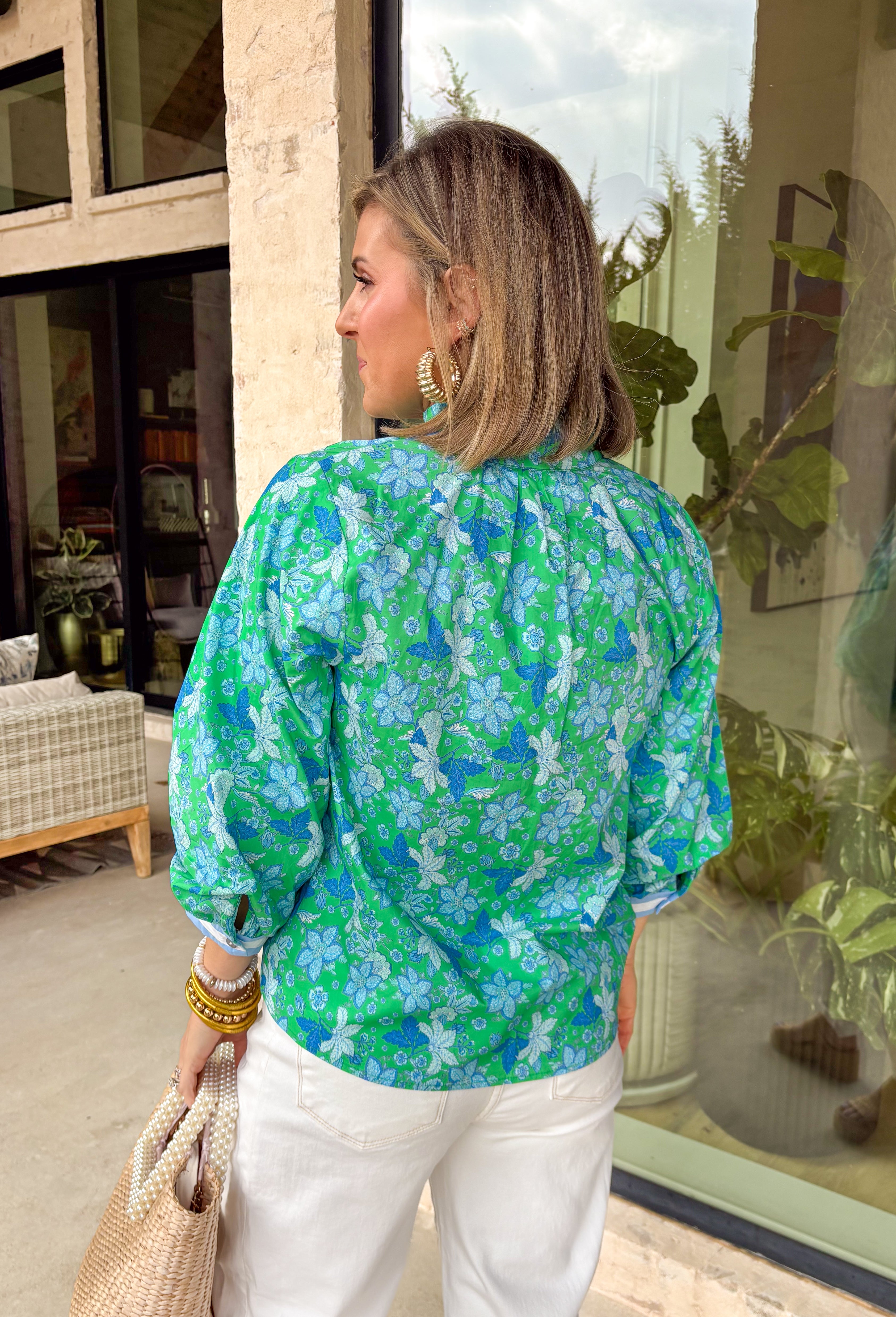 Fresh, bright, and made for spring days, this green long sleeve top by Entro is an easy statement piece you’ll reach for on repeat. Featuring a beautiful blue floral print throughout, it brings a cheerful pop of color while still feeling classic and wearable. The light blue and white contrasting band along the front adds a fun touch of detail that gives it a little extra something. Made from breathable cotton, it’s perfect for those in-between spring days when you want coverage without feeling heavy.