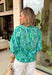 Fresh, bright, and made for spring days, this green long sleeve top by Entro is an easy statement piece you’ll reach for on repeat. Featuring a beautiful blue floral print throughout, it brings a cheerful pop of color while still feeling classic and wearable. The light blue and white contrasting band along the front adds a fun touch of detail that gives it a little extra something. Made from breathable cotton, it’s perfect for those in-between spring days when you want coverage without feeling heavy.