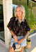 This black floral top is such a fun, vibrant pick for summer! The colorful mix of yellow, orange, purple, and green pops beautifully against the black base, making it an easy statement piece. The scalloped neckline and hem add the sweetest feminine detail, while the puff sleeves with elastic give it that flattering, easy shape. Lightweight and breathable in 100% cotton, it’s perfect for warm days when you still want to feel put together. 