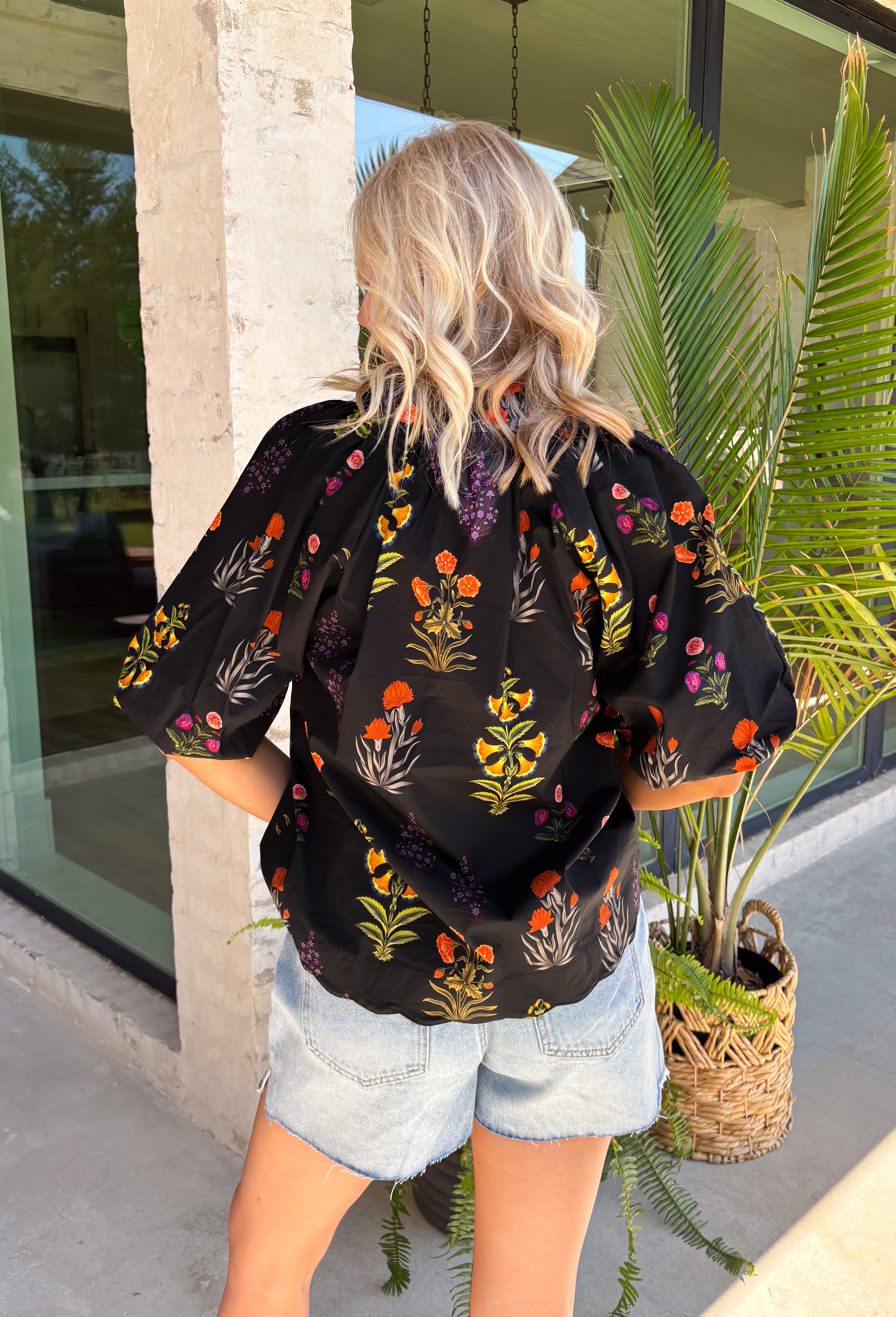 This black floral top is such a fun, vibrant pick for summer! The colorful mix of yellow, orange, purple, and green pops beautifully against the black base, making it an easy statement piece. The scalloped neckline and hem add the sweetest feminine detail, while the puff sleeves with elastic give it that flattering, easy shape. Lightweight and breathable in 100% cotton, it’s perfect for warm days when you still want to feel put together. 