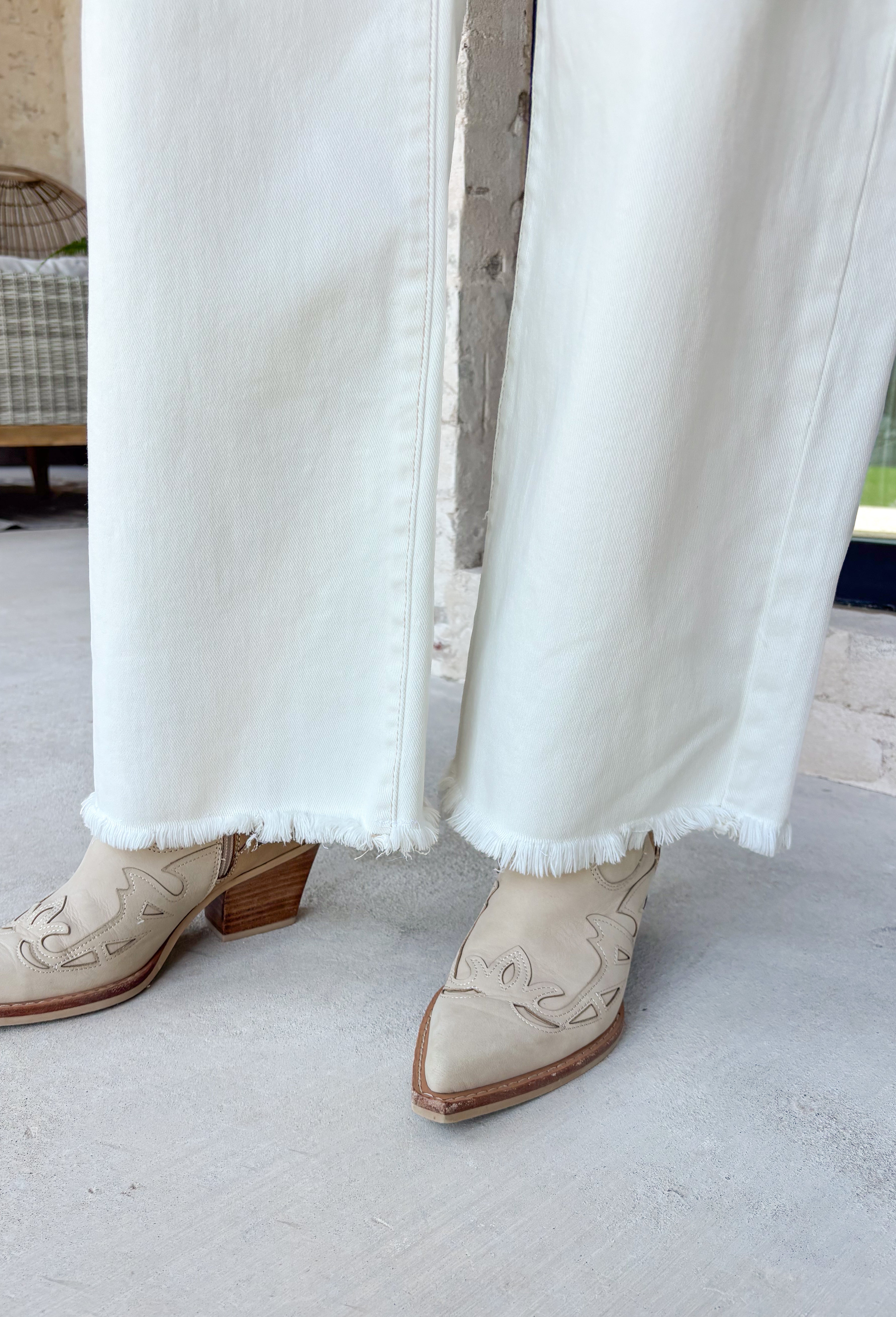 Meet the jeans you'll style with everything this season! These cream tummy control wide leg jeans are the perfect combination of flattering fit and everyday comfort. Designed with Risen's signature tummy control panel, they offer a smooth, supportive silhouette while maintaining all-day comfort. Crafted from clean, classic cream denim with warm tan stitching throughout, they're finished with a modern wide leg and raw hem for a timeless look you'll wear on repeat. 