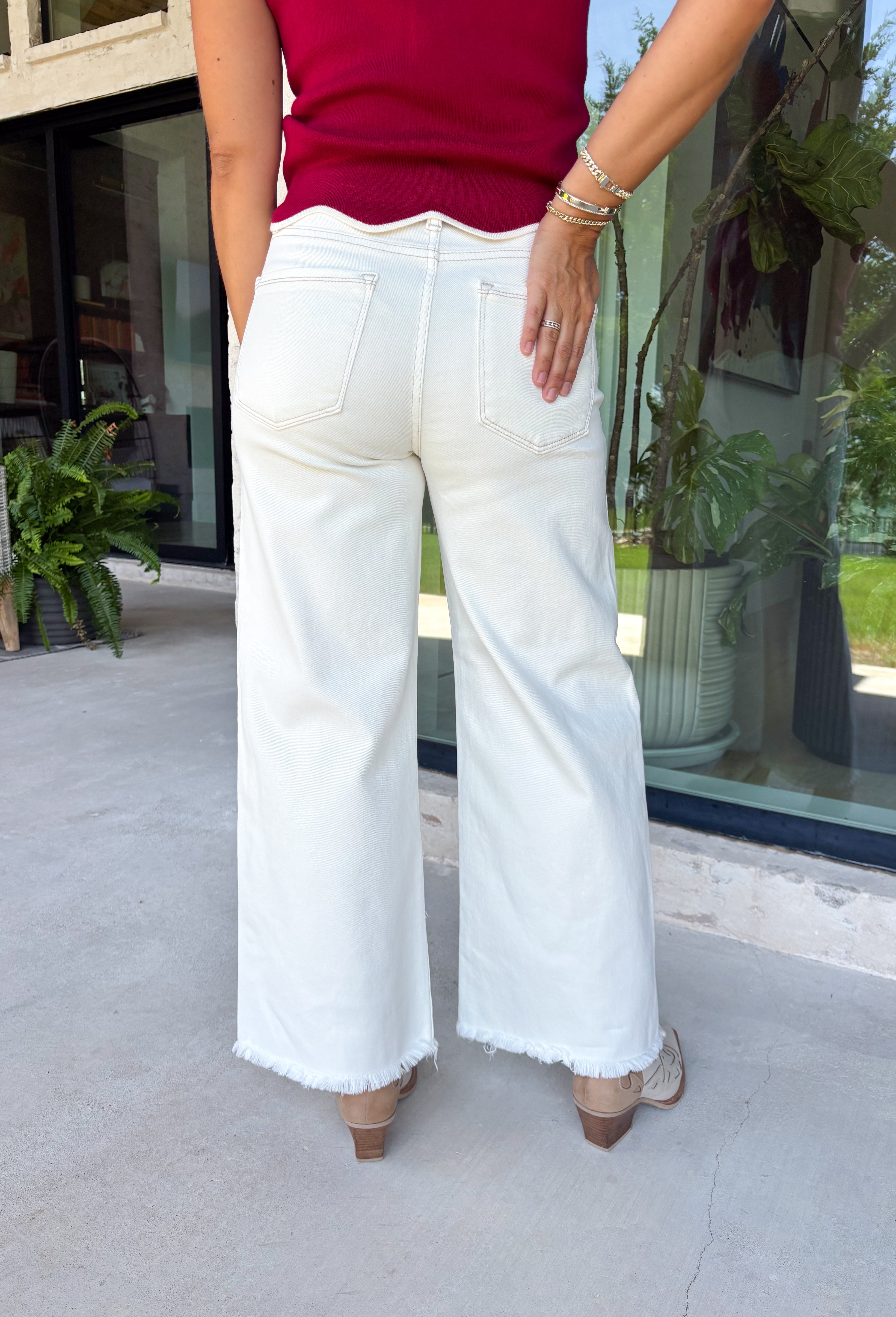 Meet the jeans you'll style with everything this season! These cream tummy control wide leg jeans are the perfect combination of flattering fit and everyday comfort. Designed with Risen's signature tummy control panel, they offer a smooth, supportive silhouette while maintaining all-day comfort. Crafted from clean, classic cream denim with warm tan stitching throughout, they're finished with a modern wide leg and raw hem for a timeless look you'll wear on repeat. 