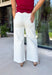 Meet the jeans you'll style with everything this season! These cream tummy control wide leg jeans are the perfect combination of flattering fit and everyday comfort. Designed with Risen's signature tummy control panel, they offer a smooth, supportive silhouette while maintaining all-day comfort. Crafted from clean, classic cream denim with warm tan stitching throughout, they're finished with a modern wide leg and raw hem for a timeless look you'll wear on repeat. 