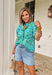 This leopard print puff sleeve top is such a fun, standout piece for summer! The light blue base with green and blue leopard print gives it a fresh, unexpected twist, while the green and white gingham ruffle trim adds the cutest pop of contrast. The band collar and button front keep it feeling polished, and the puff sleeves with elastic openings bring that soft, feminine shape. Made from breathable cotton, it’s perfect for warm days when you still want to feel put together. Pair it with white denim or short