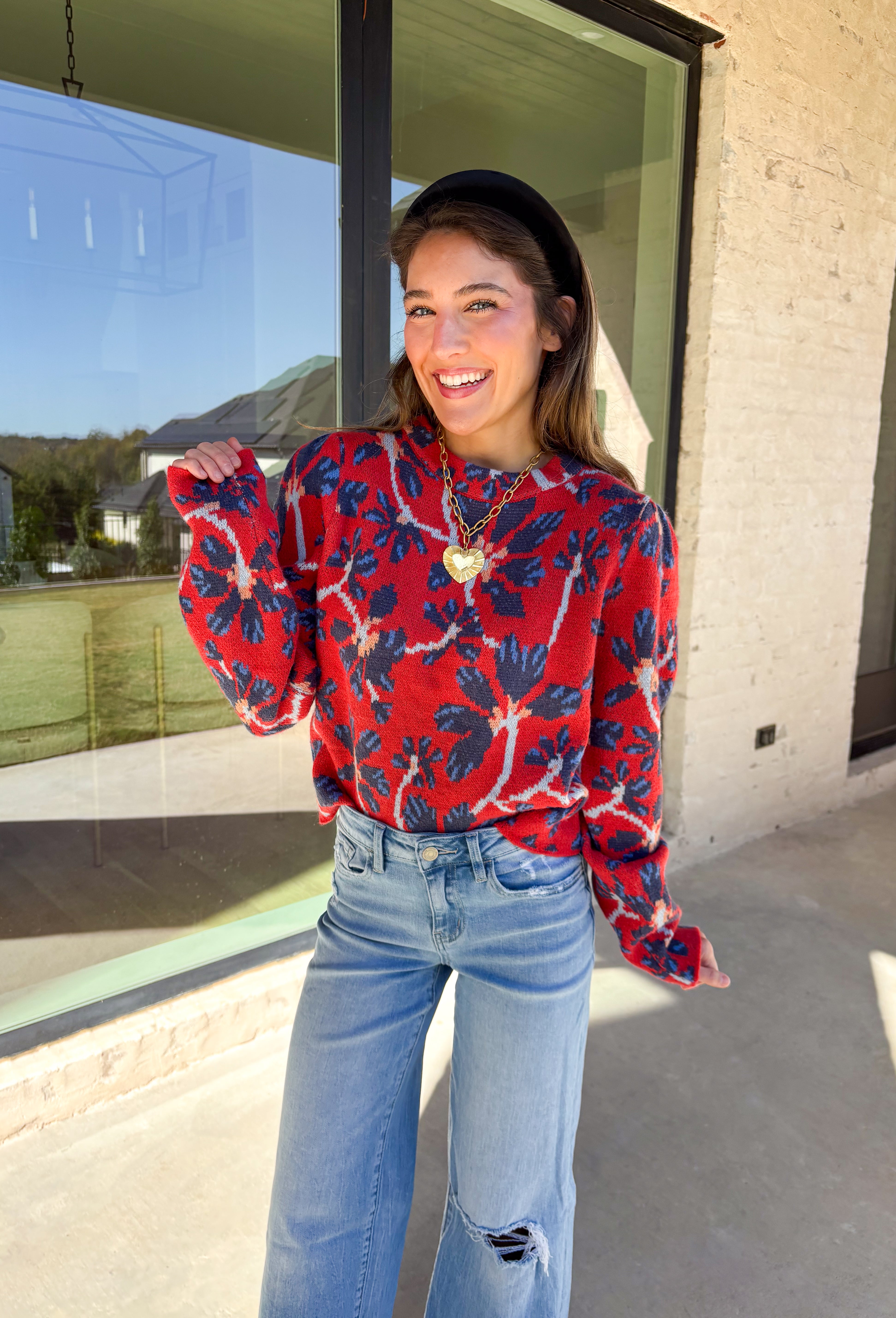 Make a statement this season in this red cropped sweater featuring an eye-catching abstract blue floral print. The cozy knit keeps you warm while the mock neck adds a touch of chic structure. With its cropped length, this sweater pairs effortlessly with high-rise jeans, skirts, or trousers—perfect for when you want comfort without sacrificing style.