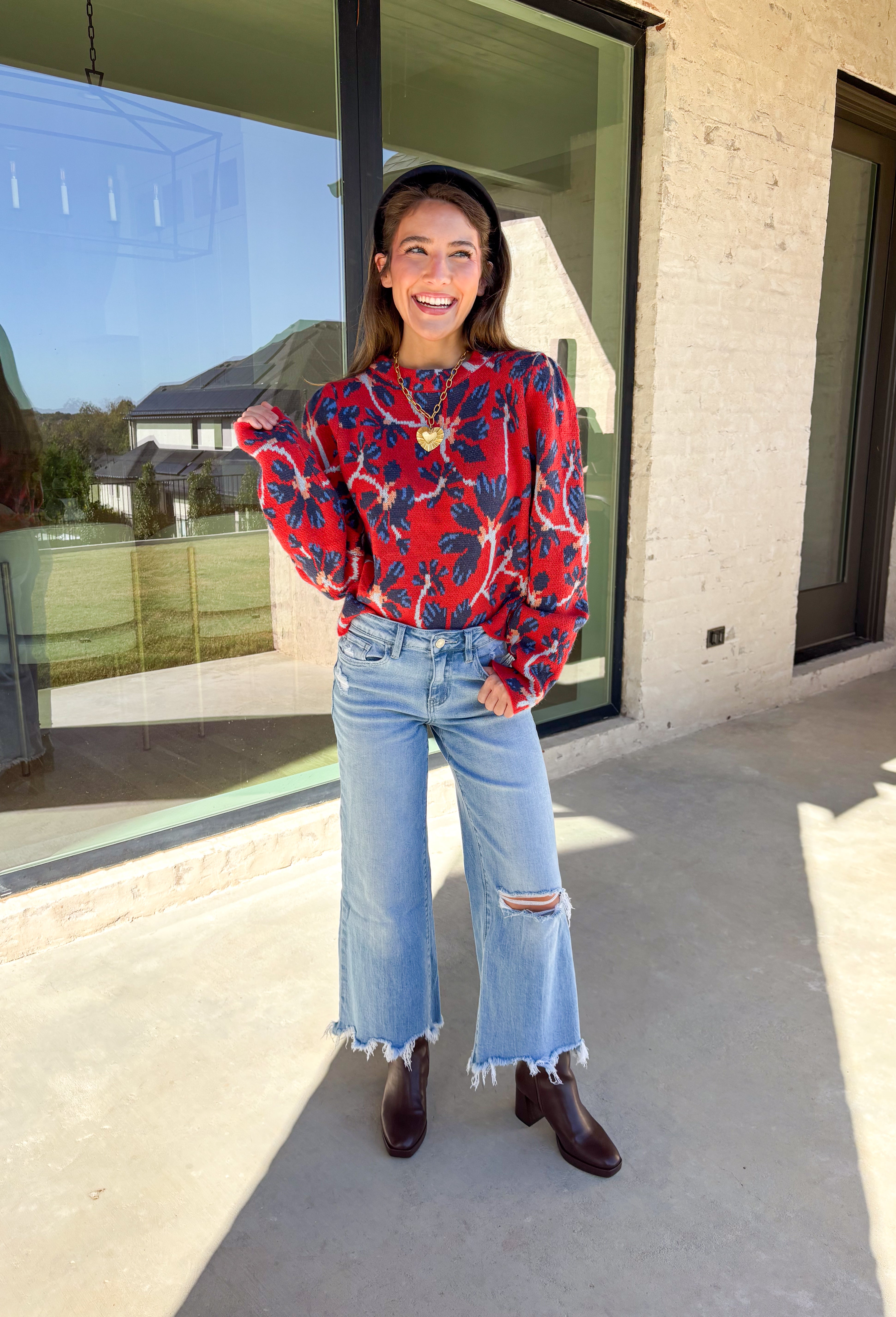 Make a statement this season in this red cropped sweater featuring an eye-catching abstract blue floral print. The cozy knit keeps you warm while the mock neck adds a touch of chic structure. With its cropped length, this sweater pairs effortlessly with high-rise jeans, skirts, or trousers—perfect for when you want comfort without sacrificing style.