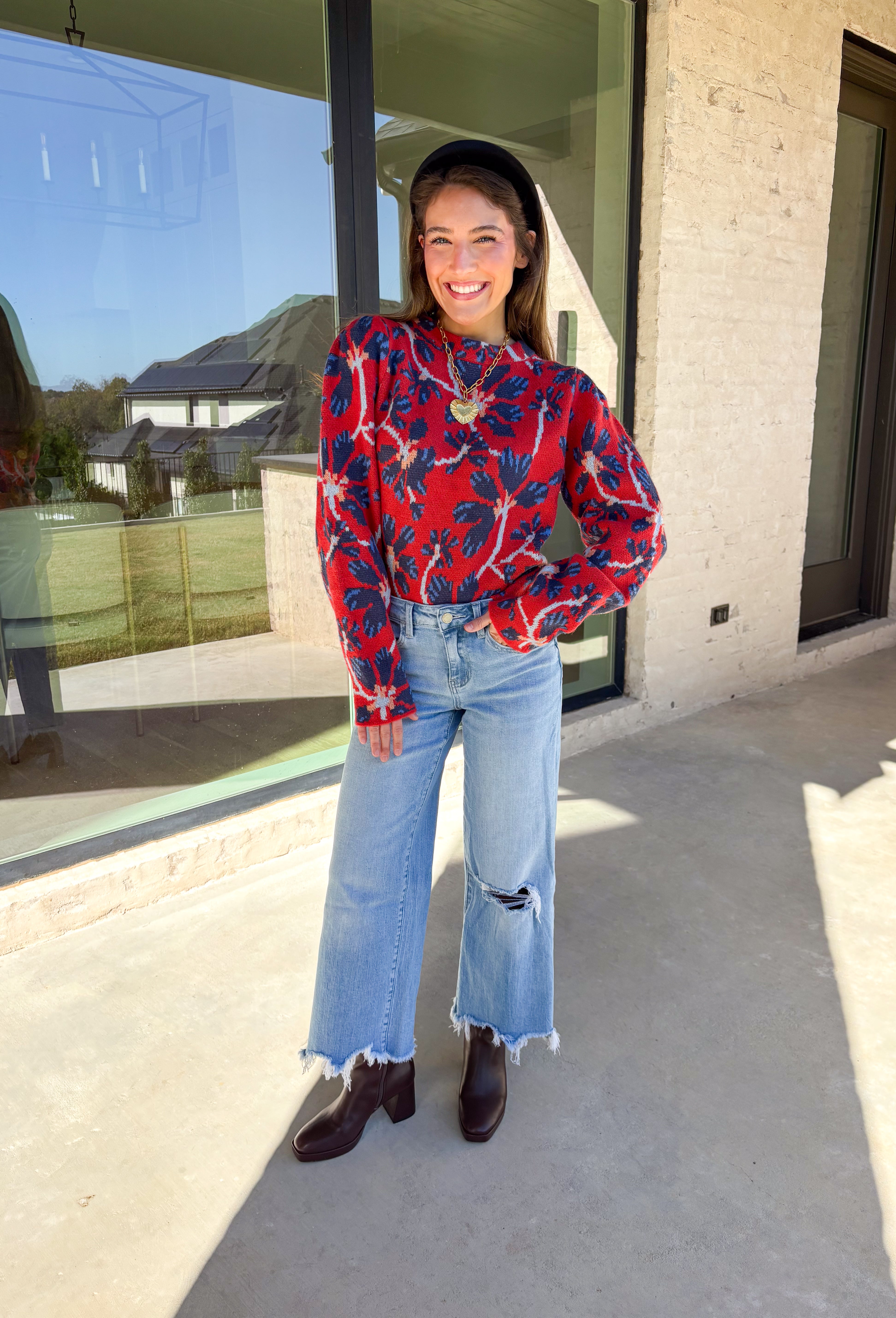 Make a statement this season in this red cropped sweater featuring an eye-catching abstract blue floral print. The cozy knit keeps you warm while the mock neck adds a touch of chic structure. With its cropped length, this sweater pairs effortlessly with high-rise jeans, skirts, or trousers—perfect for when you want comfort without sacrificing style.