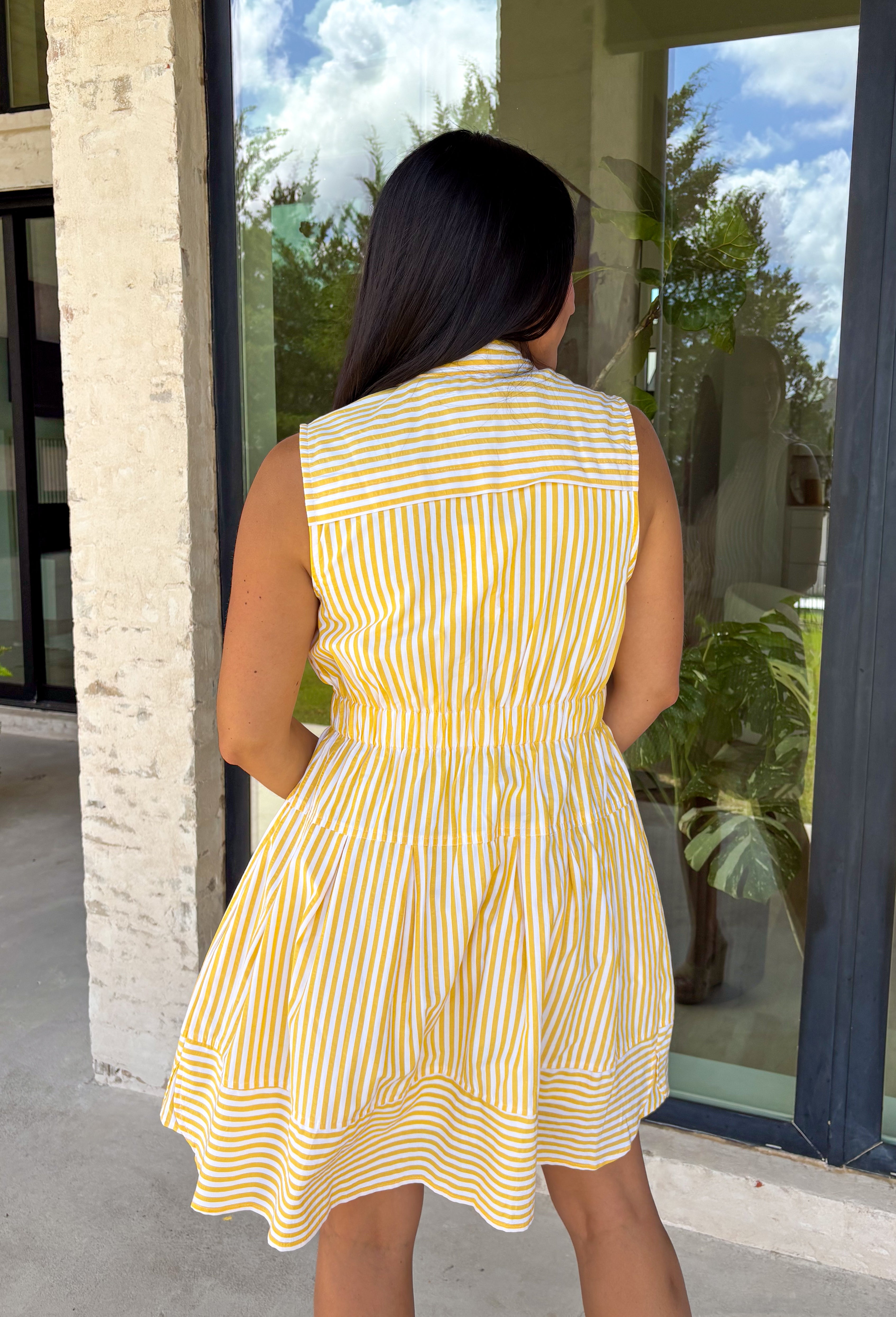 This sleeveless yellow and white striped dress by Entro is the definition of easy spring style! It’s bright, classic, and so effortless—aka the kind of piece you can throw on and instantly feel put-together. The button-down front gives it that timeless shirt dress vibe, while the tiered skirt adds a soft, flowy shape that feels fun and feminine without being fussy. The elastic waist helps create a flattering fit.