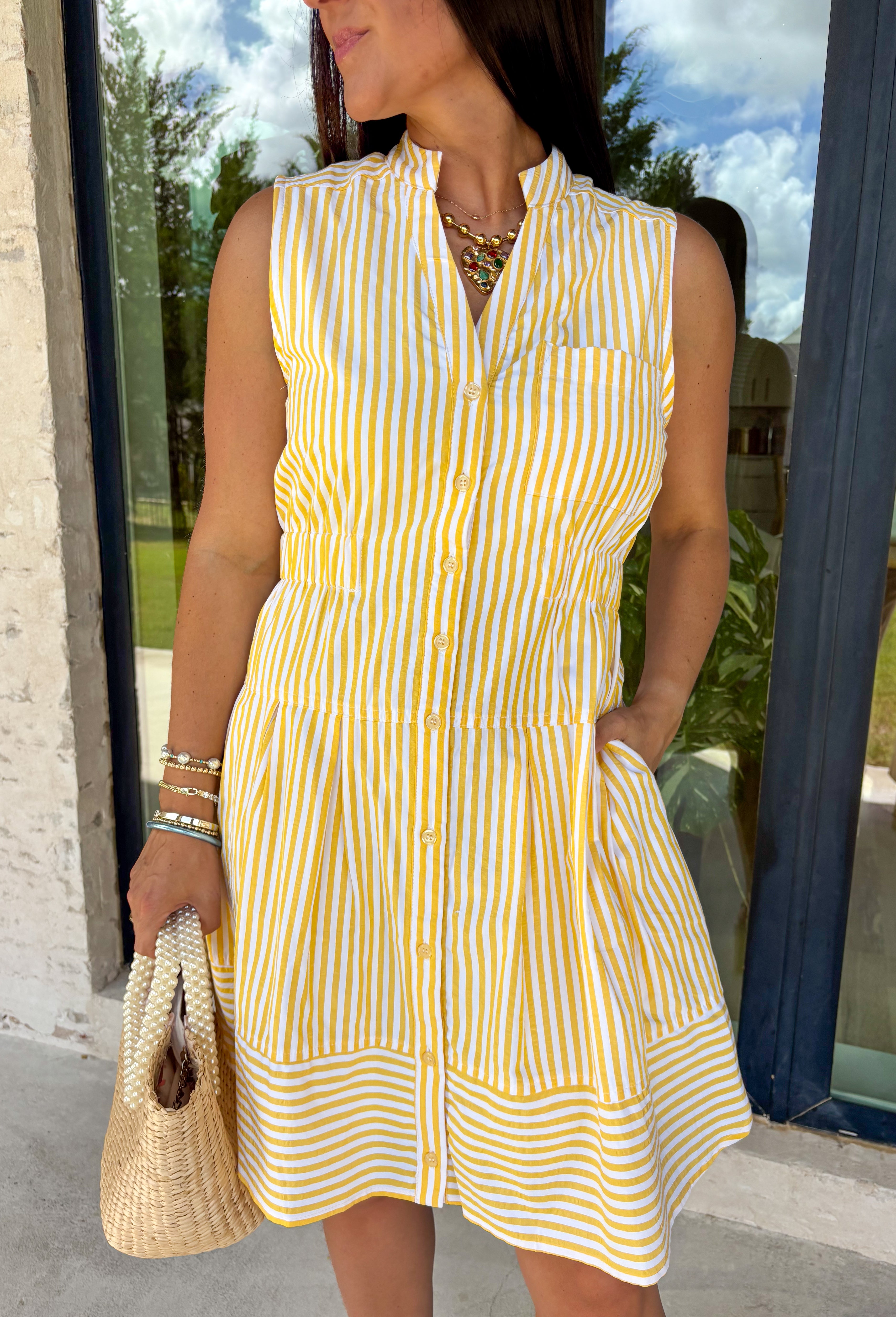 This sleeveless yellow and white striped dress by Entro is the definition of easy spring style! It’s bright, classic, and so effortless—aka the kind of piece you can throw on and instantly feel put-together. The button-down front gives it that timeless shirt dress vibe, while the tiered skirt adds a soft, flowy shape that feels fun and feminine without being fussy. The elastic waist helps create a flattering fit.