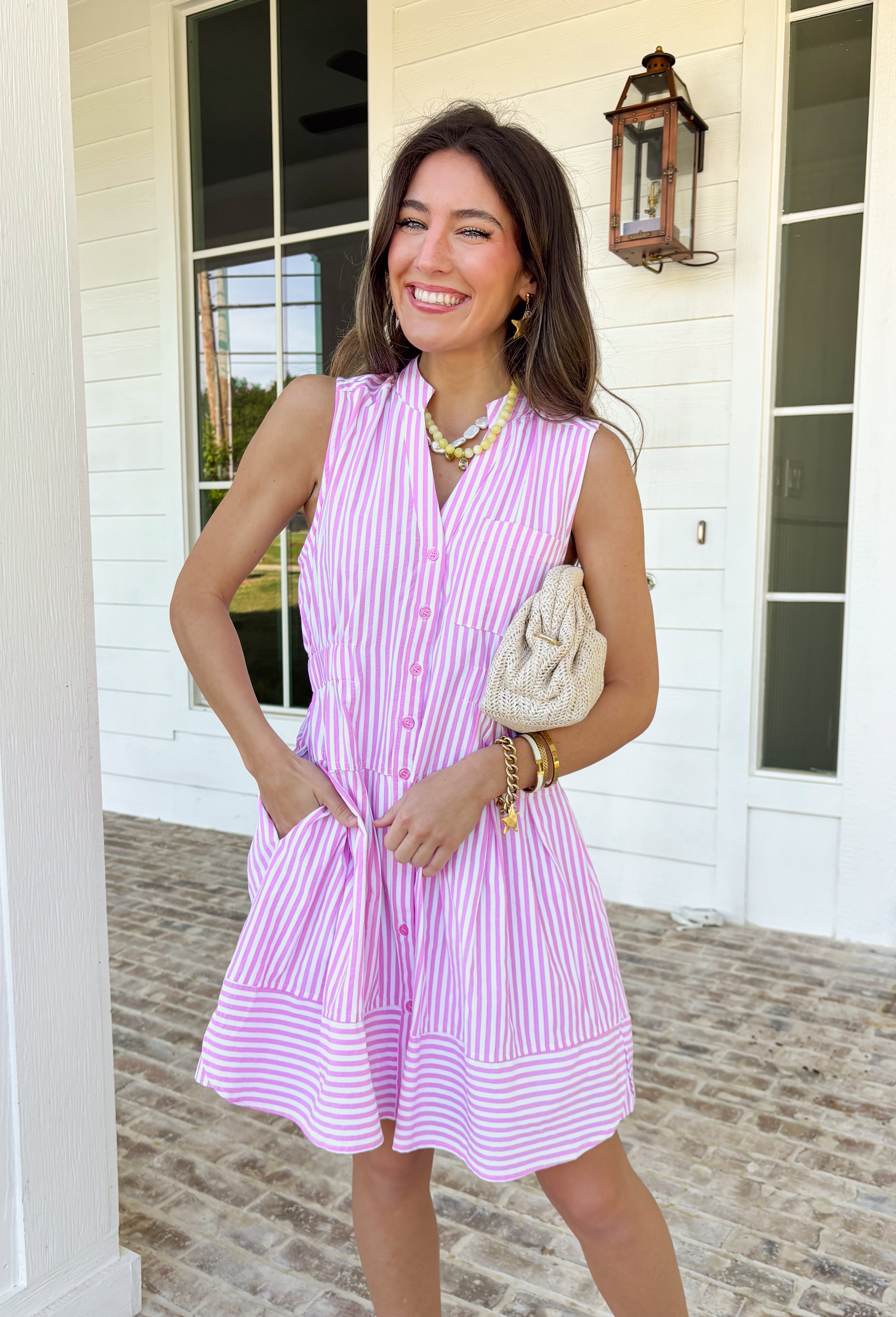 This sleeveless pink and white striped dress by Entro is the definition of easy spring style! It’s bright, classic, and so effortless—aka the kind of piece you can throw on and instantly feel put-together. The button-down front gives it that timeless shirt dress vibe, while the tiered skirt adds a soft, flowy shape that feels fun and feminine without being fussy. The elastic waist helps create a flattering fit.