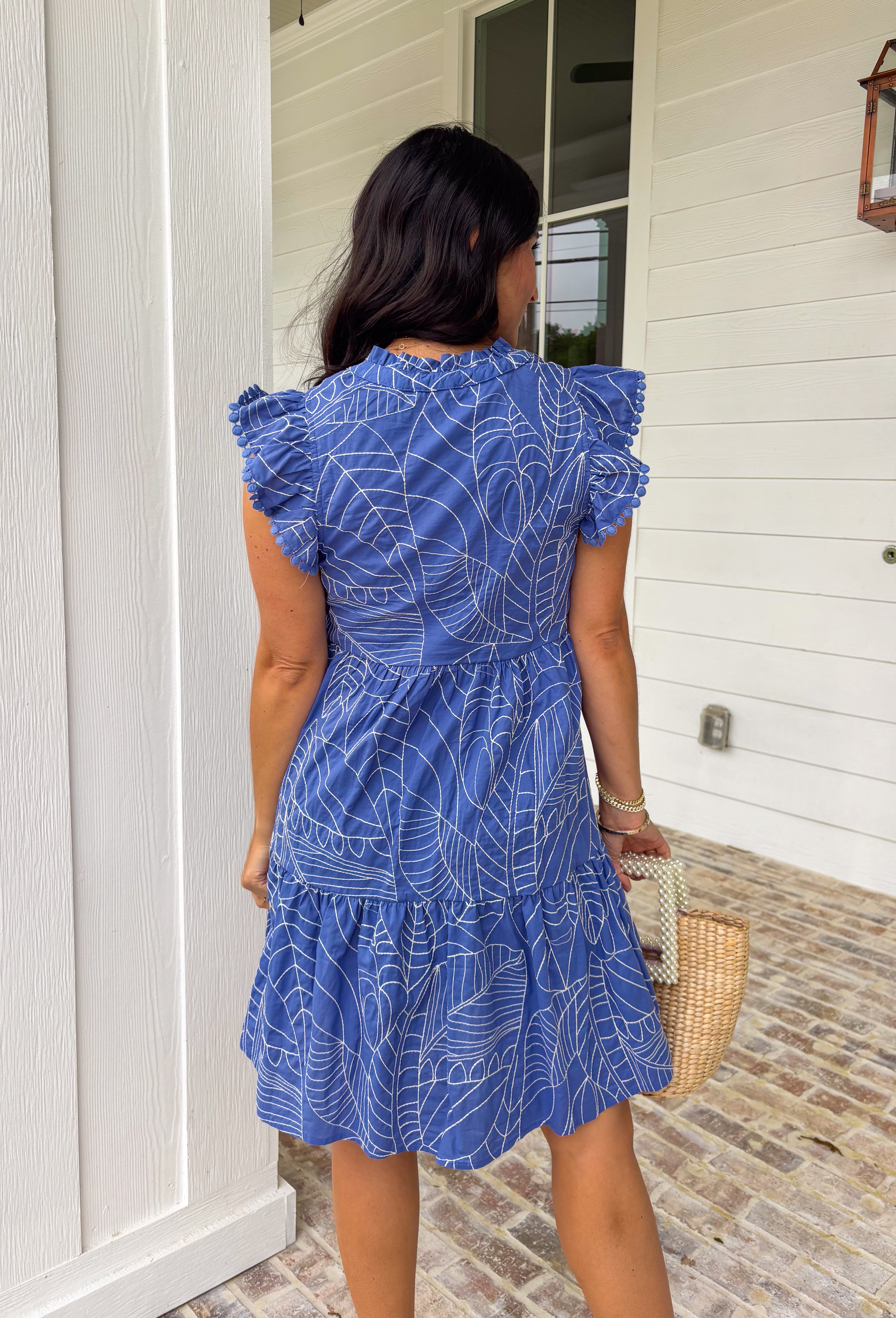 Easy, breezy, and full of tropical charm! This blue short sleeve tiered dress features a beautiful white embroidered leaf print that gives it that fresh, getaway-ready feel. The flowy tiered silhouette adds movement and comfort, making it perfect for warm spring days. Finished with embroidered trim on the sleeves for an extra touch of detail, this dress blends relaxed style with a polished look. 