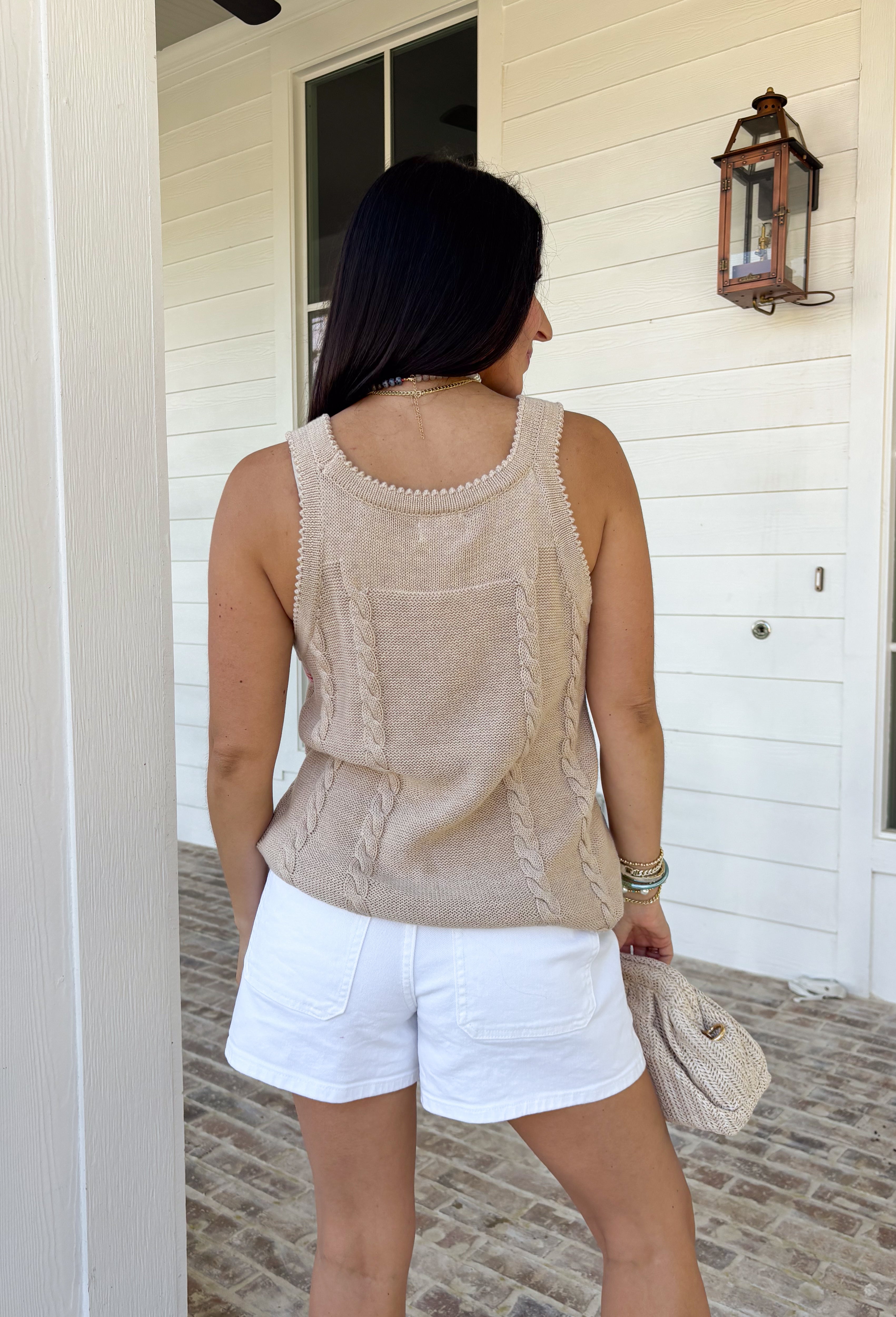 Meet your new golden hour favorite! This neutral sweater tank features a dreamy abstract sun print in shades of pink, orange, and purple — the prettiest pop of color against a soft, wearable base. It’s bold enough to stand out, yet neutral enough to pair with just about anything. Cable knit texture throughout adds cozy dimension, while the open knit detailing along the hem and top keeps it lightweight and breathable. Finished with scalloped edges along the sleeves and neckline.