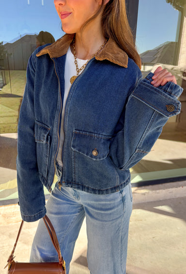Classic and effortlessly cool, this denim barn jacket by Haute Monde is the perfect layer for the winter season. Featuring a soft brown corduroy collar and zip-front closure, it blends timeless design with everyday comfort. Functional front pockets and structured denim give it that lived-in look you’ll love for layering over your favorite winter sweaters or flannels.