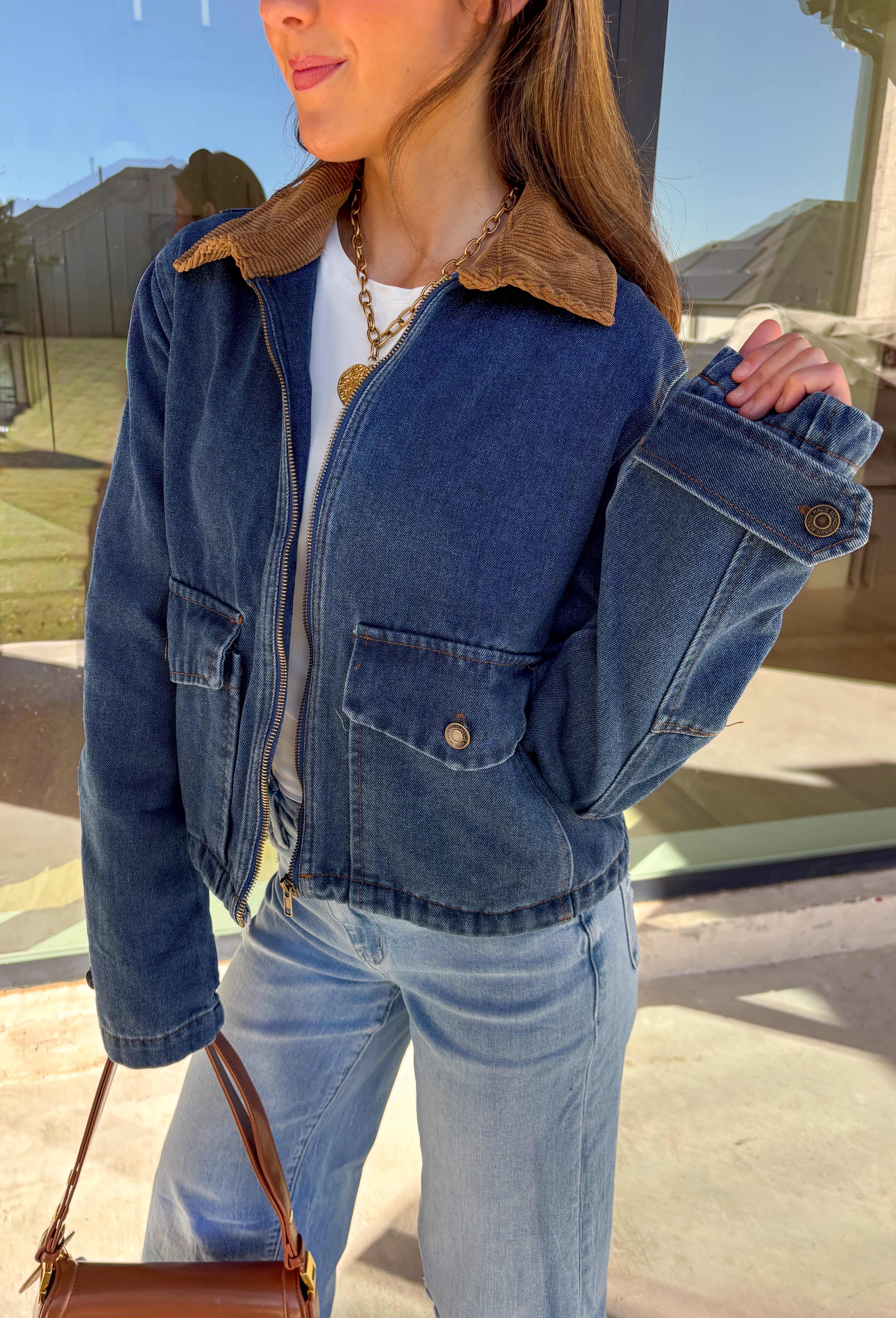 Classic and effortlessly cool, this denim barn jacket by Haute Monde is the perfect layer for the winter season. Featuring a soft brown corduroy collar and zip-front closure, it blends timeless design with everyday comfort. Functional front pockets and structured denim give it that lived-in look you’ll love for layering over your favorite winter sweaters or flannels.