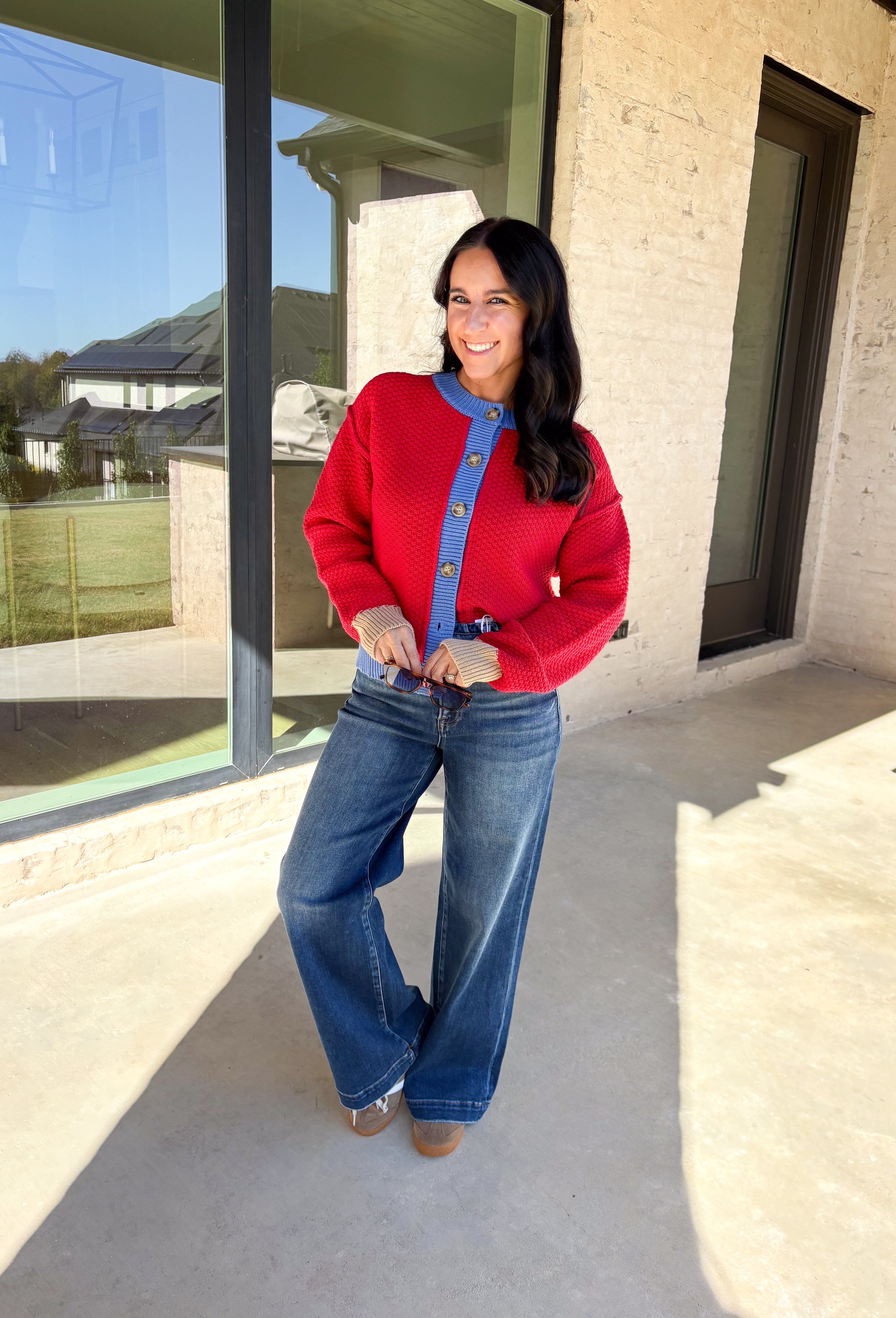 A cozy layering essential with a playful twist! This red knit button down cardigan features hints of periwinkle woven throughout for a fun pop of color, plus a contrasting tan trim on the sleeves for that little something extra. It’s the kind of cardigan you’ll reach for all season long—whether you're lounging or layering up for fall errands.