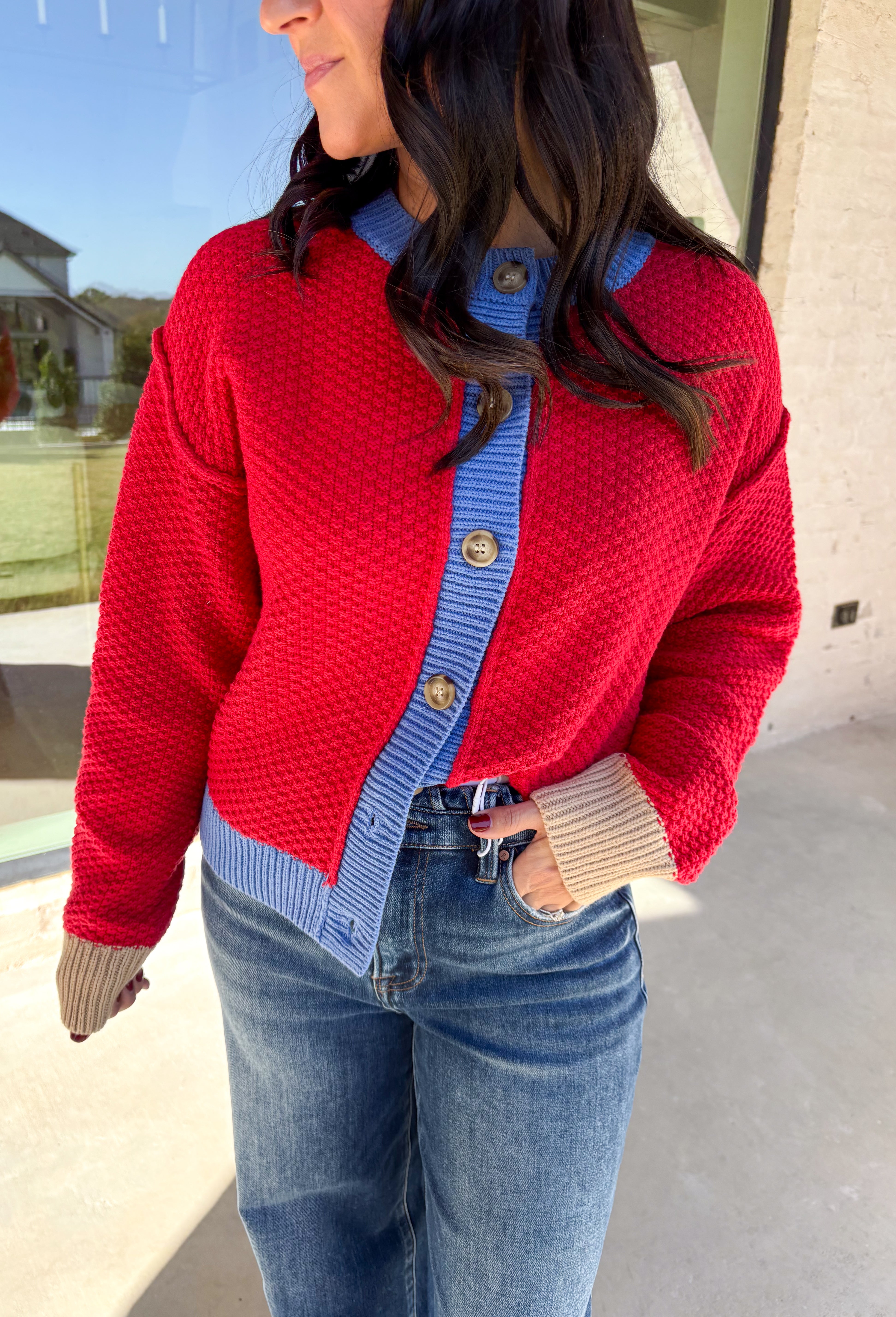 A cozy layering essential with a playful twist! This red knit button down cardigan features hints of periwinkle woven throughout for a fun pop of color, plus a contrasting tan trim on the sleeves for that little something extra. It’s the kind of cardigan you’ll reach for all season long—whether you're lounging or layering up for fall errands.