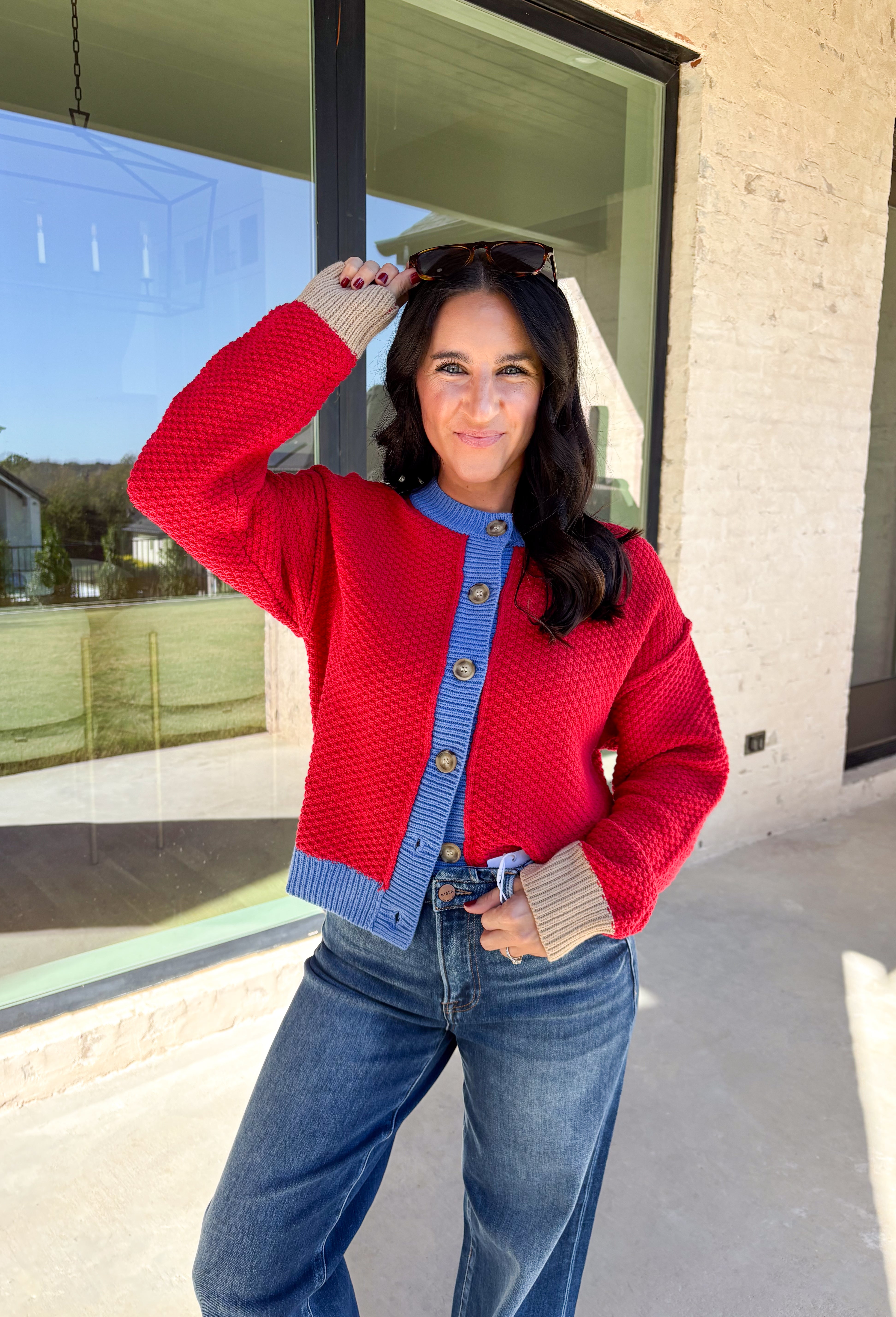 A cozy layering essential with a playful twist! This red knit button down cardigan features hints of periwinkle woven throughout for a fun pop of color, plus a contrasting tan trim on the sleeves for that little something extra. It’s the kind of cardigan you’ll reach for all season long—whether you're lounging or layering up for fall errands.