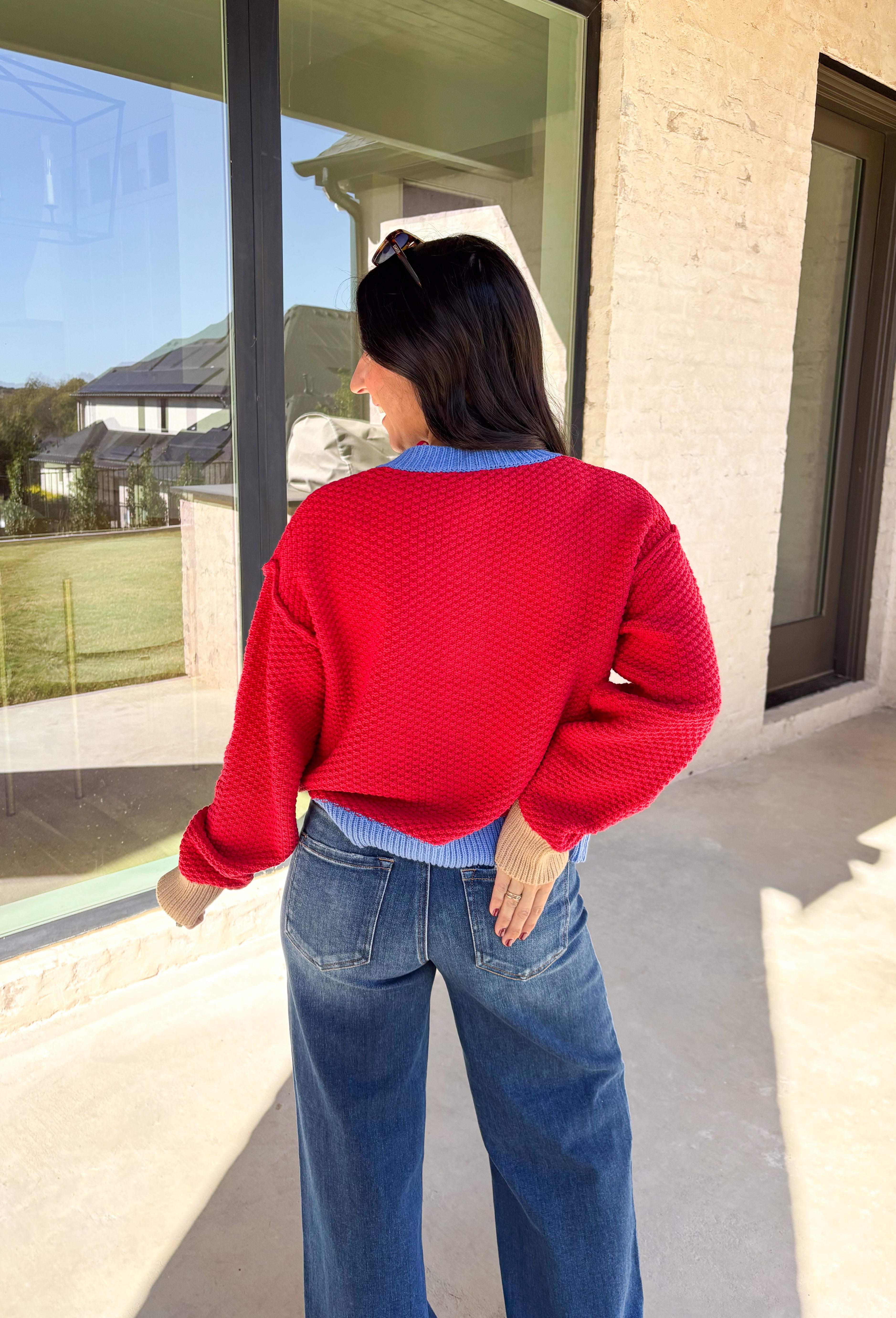A cozy layering essential with a playful twist! This red knit button down cardigan features hints of periwinkle woven throughout for a fun pop of color, plus a contrasting tan trim on the sleeves for that little something extra. It’s the kind of cardigan you’ll reach for all season long—whether you're lounging or layering up for fall errands.