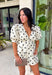 Classic polka dots and effortless style come together in this adorable two-piece set from Mable. Featuring an off-white and black polka dot print, this coordinating outfit is as versatile as it is charming. The short sleeve top is designed with feminine puff sleeves, a single button closure at the front, and a sweet tie detail at the back for an elevated finish. The matching shorts feature a comfortable elastic waistband, side zipper closure, and functional side pockets.