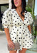 Classic polka dots and effortless style come together in this adorable two-piece set from Mable. Featuring an off-white and black polka dot print, this coordinating outfit is as versatile as it is charming. The short sleeve top is designed with feminine puff sleeves, a single button closure at the front, and a sweet tie detail at the back for an elevated finish. The matching shorts feature a comfortable elastic waistband, side zipper closure, and functional side pockets.