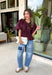 Elevate your everyday wardrobe with this beautifully detailed top from Entro. Designed in a rich merlot hue, this timeless blouse features elegant pleating throughout for added texture and a polished finish. Decorative front button details add classic charm, while the puff sleeves create a feminine silhouette that's easy to dress up or down. Crafted from a lightweight fabric blend, this versatile top is perfect for everything from workdays to weekend brunches and seasonal gatherings.