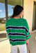 Classic with a fresh spring twist, this striped knit sweater by Entro is an easy piece to reach for on cooler spring days. Featuring a round neckline and ¾ length sleeves, it’s finished with subtle cable knit detailing that adds texture without feeling heavy. The green base is accented with black, blue, and white stripes, giving it a timeless look that pairs effortlessly with denim, trousers, or skirts.