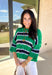 Classic with a fresh spring twist, this striped knit sweater by Entro is an easy piece to reach for on cooler spring days. Featuring a round neckline and ¾ length sleeves, it’s finished with subtle cable knit detailing that adds texture without feeling heavy. The green base is accented with black, blue, and white stripes, giving it a timeless look that pairs effortlessly with denim, trousers, or skirts.