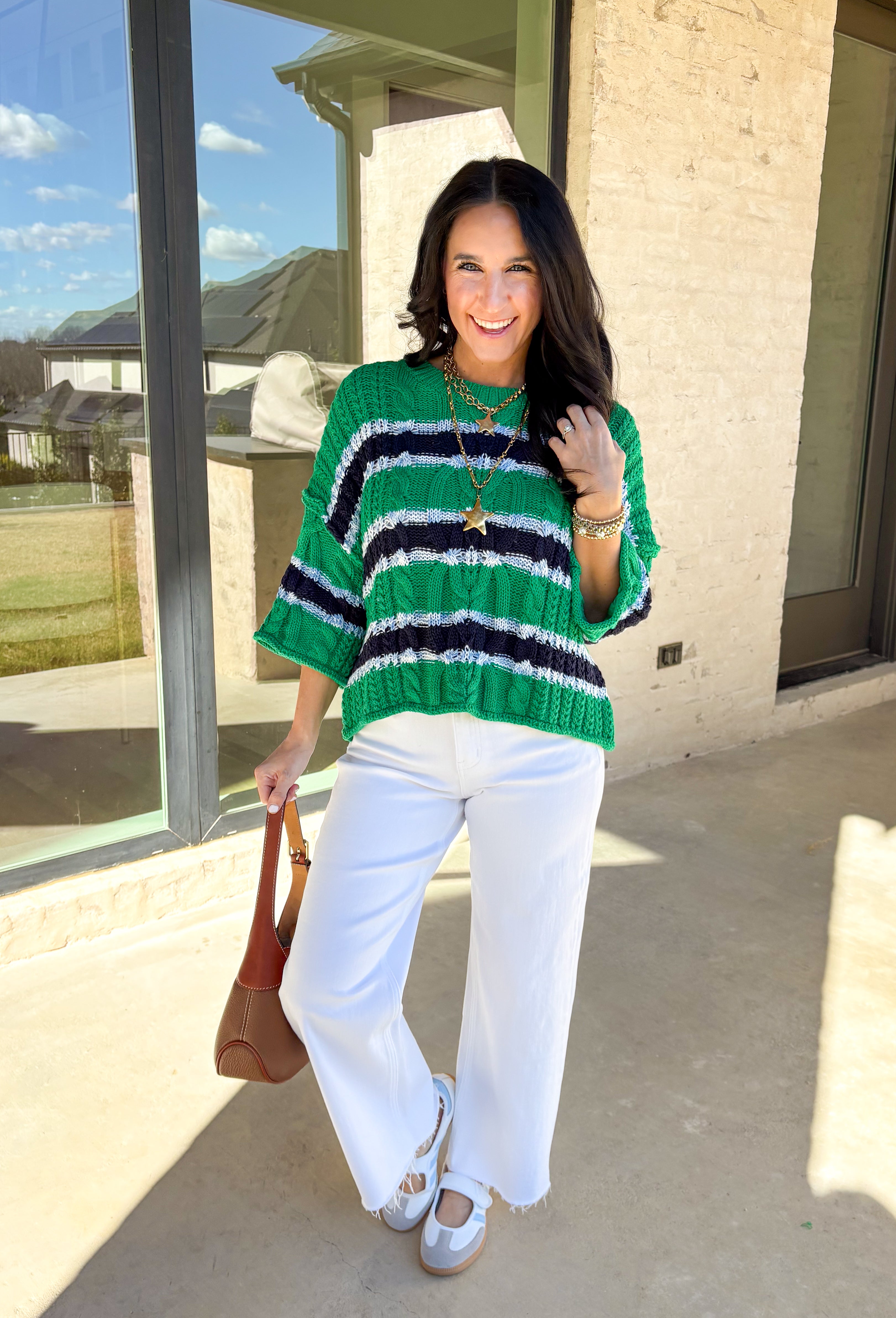 Classic with a fresh spring twist, this striped knit sweater by Entro is an easy piece to reach for on cooler spring days. Featuring a round neckline and ¾ length sleeves, it’s finished with subtle cable knit detailing that adds texture without feeling heavy. The green base is accented with black, blue, and white stripes, giving it a timeless look that pairs effortlessly with denim, trousers, or skirts.