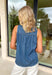 Easy, breezy, and perfect for spring layering, this sleeveless medium wash denim top by Doe and Rae is an effortless wardrobe staple. Made from a lightweight tencel blend, it has that soft, lived-in denim feel without the heaviness. The raw edge hem gives it a relaxed, casual vibe, while the keyhole back closure adds a sweet finishing touch. This top is perfect for pairing with white denim, shorts, or layering under a light jacket when the spring breeze hits.