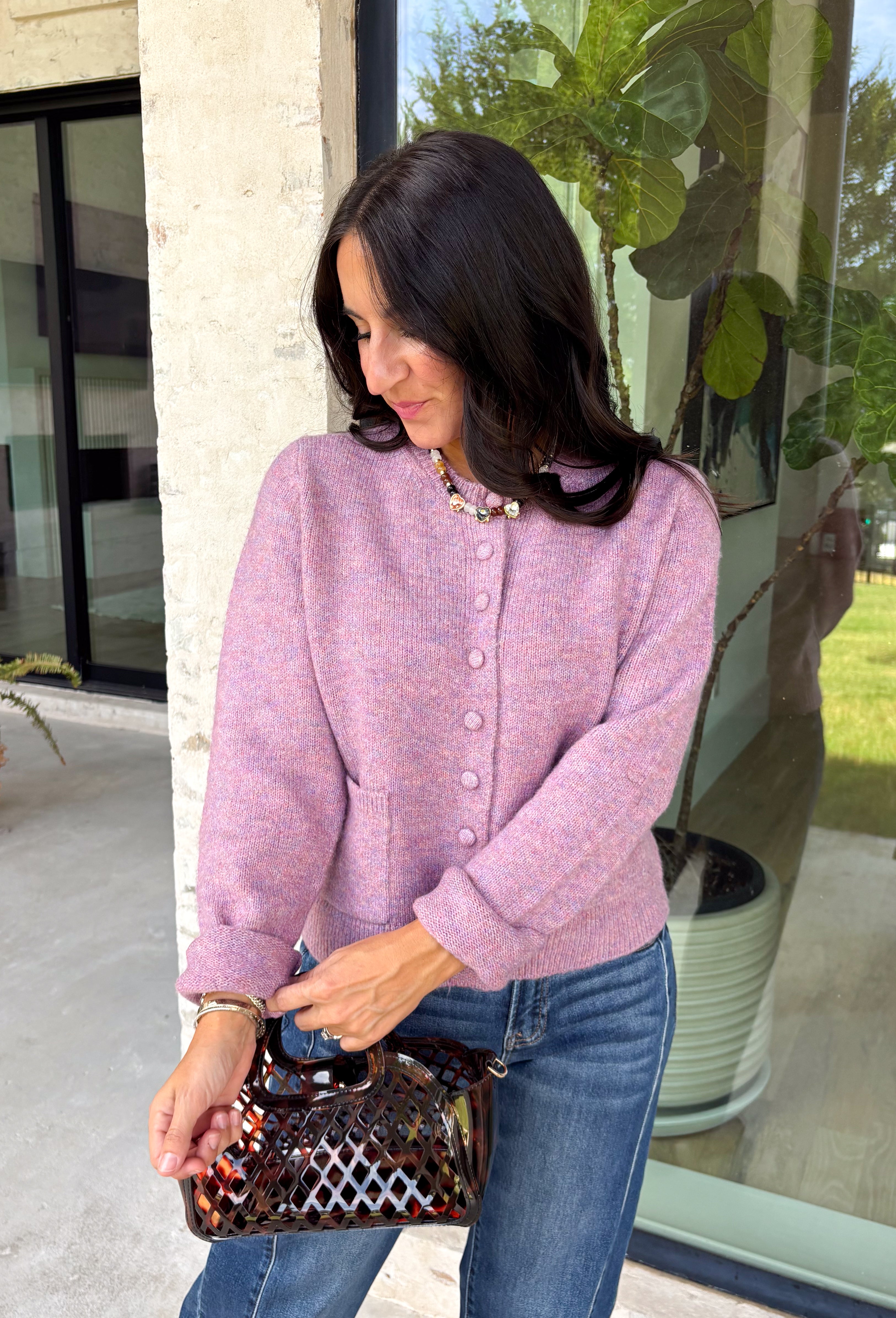 Wrap yourself in all the cozy vibes this season with this beautiful knit cardigan! Featuring gorgeous shades of purple woven throughout, this button-down cardigan is the perfect layering piece for crisp autumn mornings and cozy evenings. Front pockets add a practical touch, while the soft knit fabric makes it one you'll reach for again and again. Whether you're heading to brunch, the office, or enjoying a weekend at the pumpkin patch, this cardigan brings effortless comfort and style to every outfit.