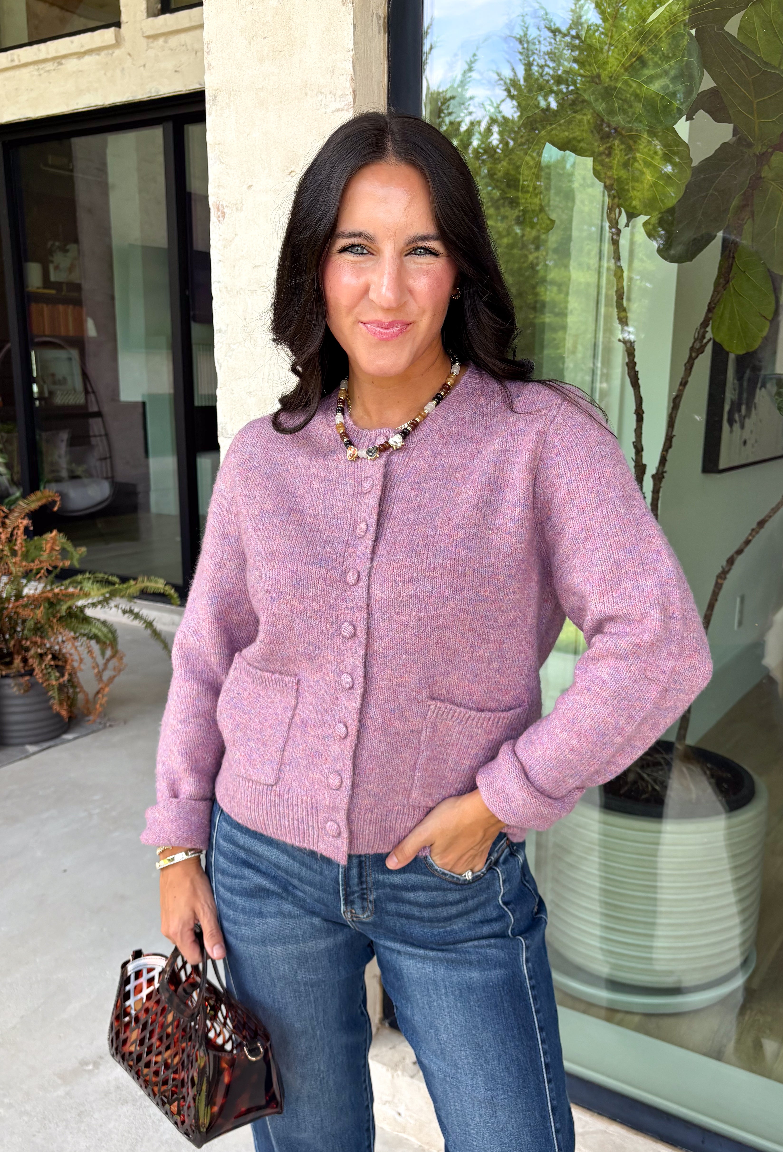 Wrap yourself in all the cozy vibes this season with this beautiful knit cardigan! Featuring gorgeous shades of purple woven throughout, this button-down cardigan is the perfect layering piece for crisp autumn mornings and cozy evenings. Front pockets add a practical touch, while the soft knit fabric makes it one you'll reach for again and again. Whether you're heading to brunch, the office, or enjoying a weekend at the pumpkin patch, this cardigan brings effortless comfort and style to every outfit.