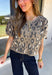 Classic leopard print gets a feminine update in this irresistibly cozy cardigan. Designed with a timeless leopard pattern, this soft sweater knit features charming puff sleeves and a classic button-front silhouette that's as versatile as it is stylish. Wear it buttoned as a top or layered over your favorite tank or tee for endless outfit possibilities. 