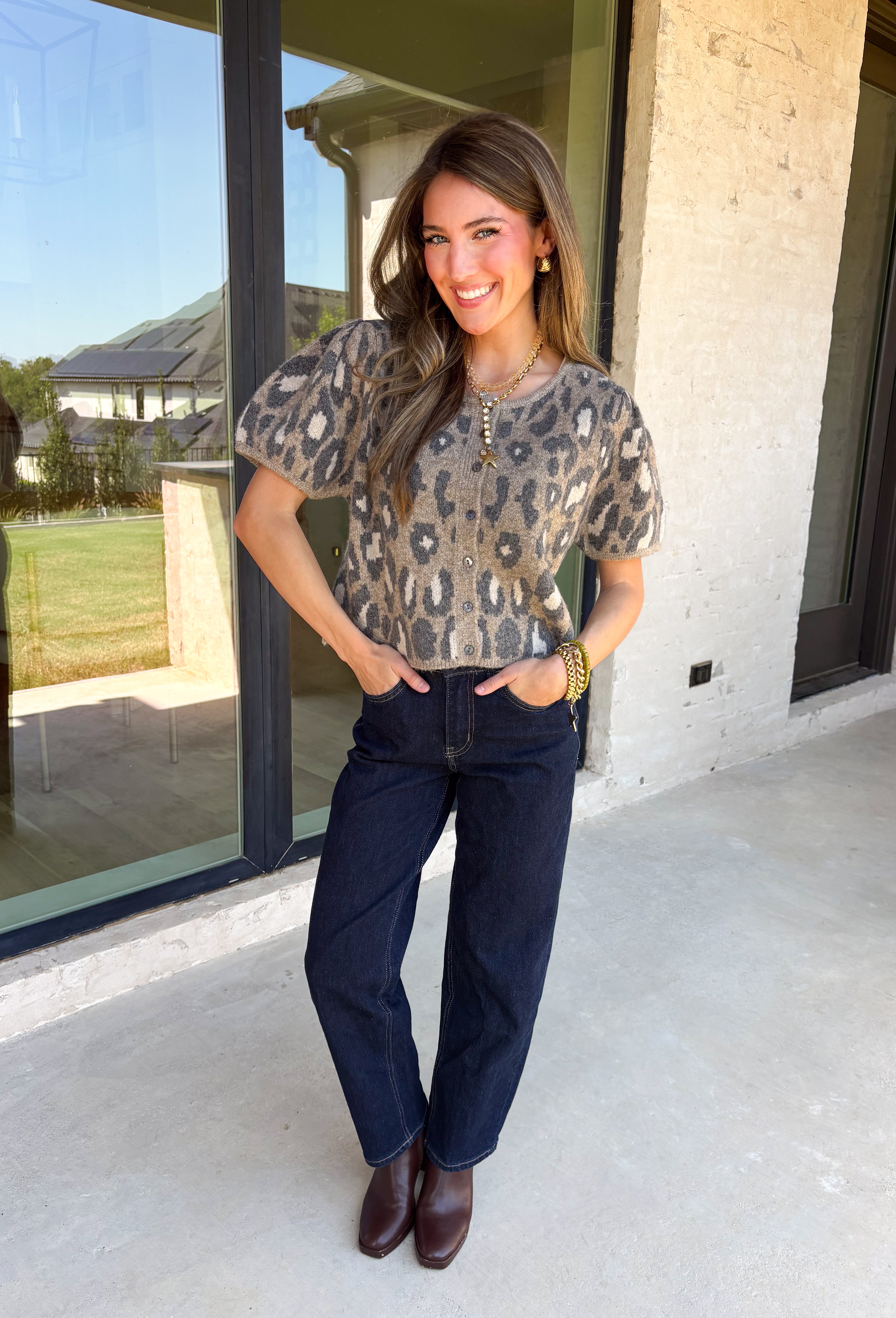 Classic leopard print gets a feminine update in this irresistibly cozy cardigan. Designed with a timeless leopard pattern, this soft sweater knit features charming puff sleeves and a classic button-front silhouette that's as versatile as it is stylish. Wear it buttoned as a top or layered over your favorite tank or tee for endless outfit possibilities. 