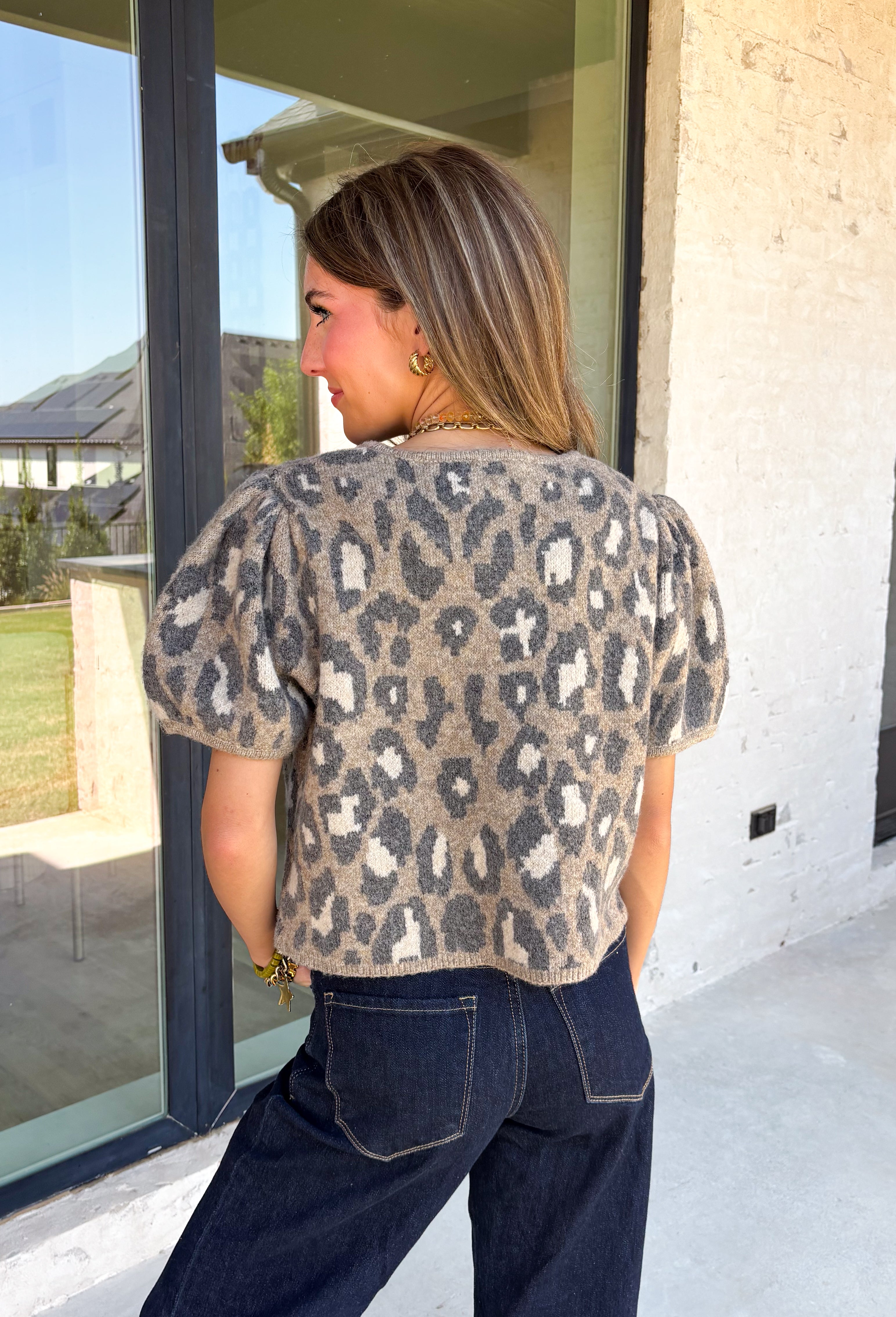 Classic leopard print gets a feminine update in this irresistibly cozy cardigan. Designed with a timeless leopard pattern, this soft sweater knit features charming puff sleeves and a classic button-front silhouette that's as versatile as it is stylish. Wear it buttoned as a top or layered over your favorite tank or tee for endless outfit possibilities. 