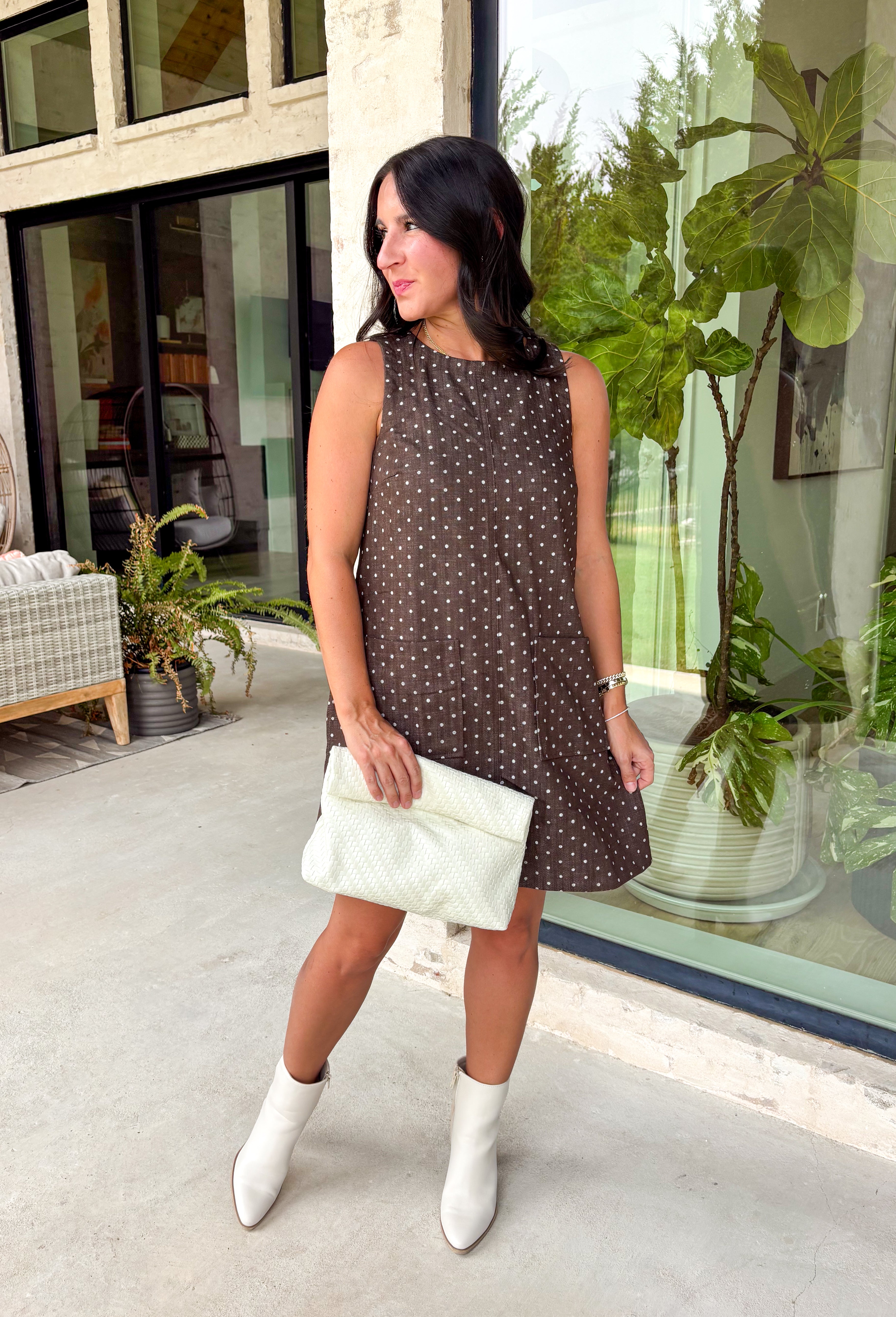 Timeless prints never go out of style, and this charming sleeveless dress is proof. Designed in a rich brown hue with a classic off-white polka dot print, this easy-to-wear dress brings effortless style to every fall occasion. The relaxed silhouette is both flattering and comfortable, while the front pockets add a practical touch you'll love. Finished with a delicate keyhole button closure at the back, this versatile dress can easily be dressed up or down.