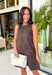 Timeless prints never go out of style, and this charming sleeveless dress is proof. Designed in a rich brown hue with a classic off-white polka dot print, this easy-to-wear dress brings effortless style to every fall occasion. The relaxed silhouette is both flattering and comfortable, while the front pockets add a practical touch you'll love. Finished with a delicate keyhole button closure at the back, this versatile dress can easily be dressed up or down.