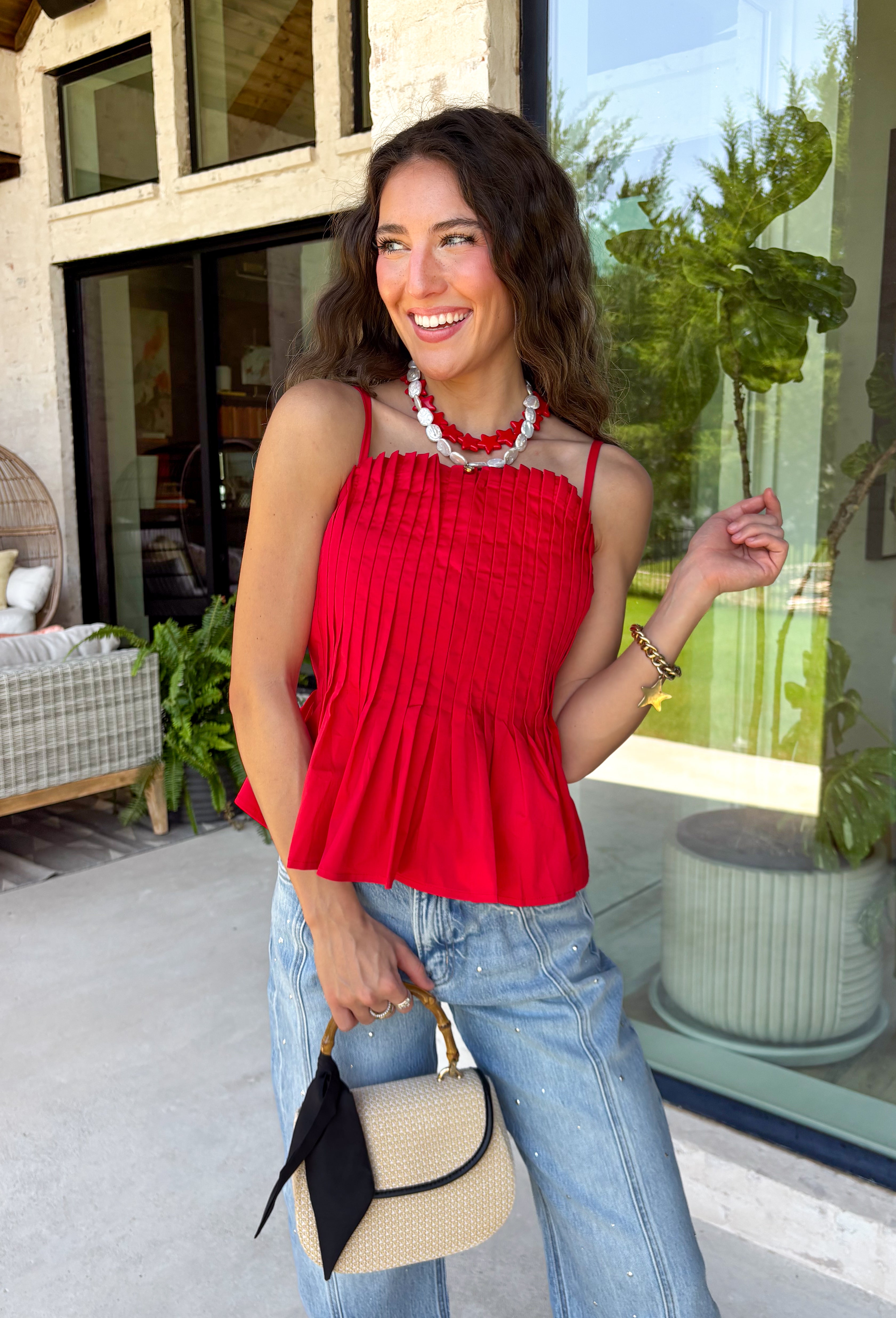 Every fall wardrobe needs a classic red cami, and this one is anything but basic! Designed with chic vertical pleating along the bodice, it adds beautiful texture and an elevated touch to any outfit. The adjustable shoulder straps and smocked back panel provide a comfortable, flattering fit, making it just as easy to wear on its own as it is layered under blazers, cardigans, or jackets. 
