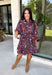 Celebrate the beauty of fall in this effortlessly chic dress from Entro. Designed with a rich brown backdrop and a beautiful floral and leaf print in autumn shades, this timeless dress is full of charming details. The classic shirt collar and button-front closure create a polished look, while the self-tie belt and elastic back waist provide a flattering, comfortable fit. Finished with ¾ balloon sleeves, a feminine tiered hem, convenient side pockets, and a fully lined design.