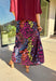 Bold and playful with a sleek twist, this satin maxi skirt is ready to steal the spotlight. The black background makes the vibrant leopard print—lime green, orange, pink, purple, and blue—pop beautifully, giving you a statement piece that still feels versatile. The elastic waistband keeps it comfortable and easy to wear, while the flowing maxi length adds a touch of drama. Perfect for dressing up with heels or styling casually with a tucked-in sweater and sneakers, this skirt brings a punch of personality t