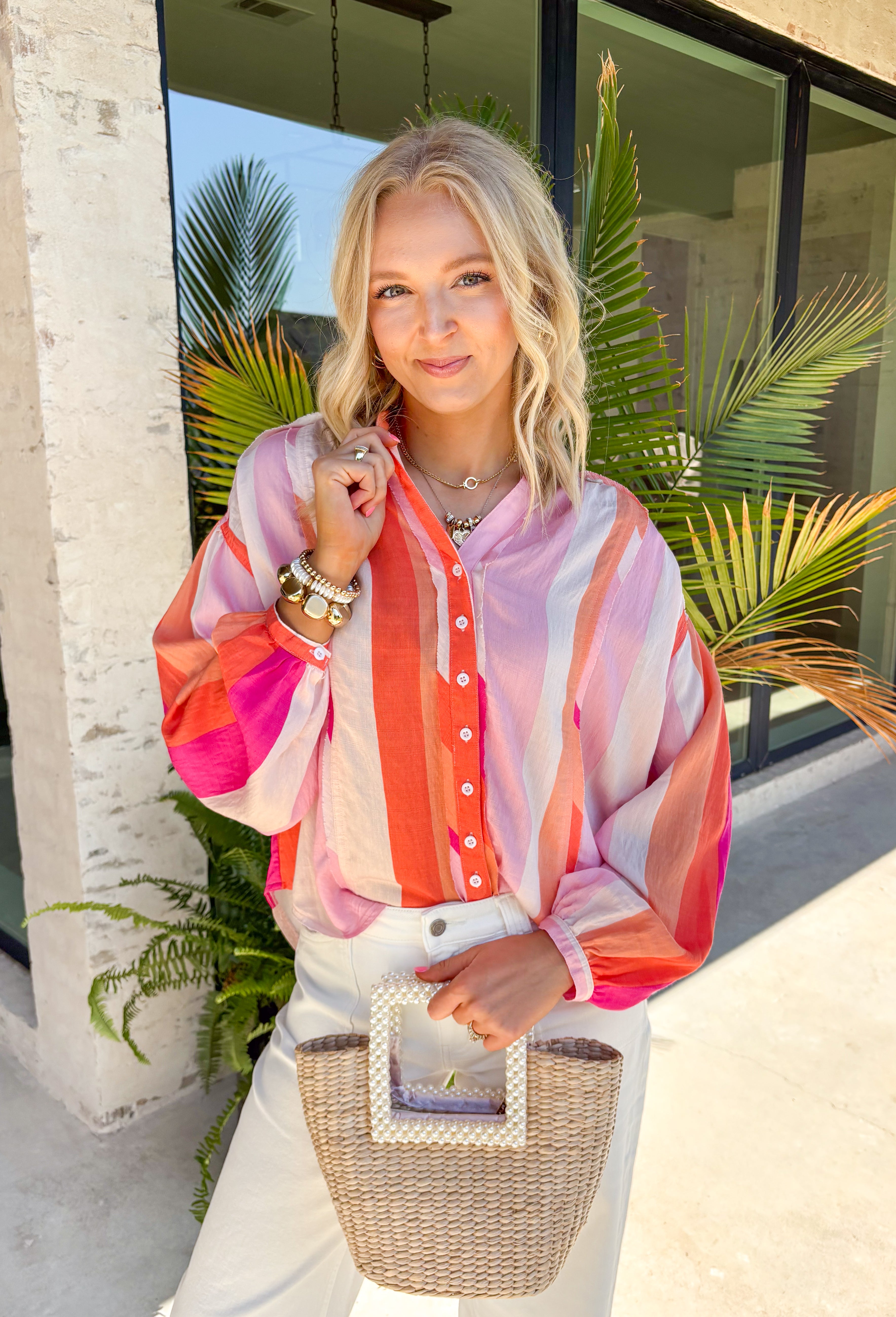 This colorful stripe button down top is bringing all the sunset-inspired summer vibes! With shades of pink and coral, it adds the prettiest pop of color while still feeling soft and easy to style. Lightweight and breathable, it’s perfect for layering over a tank or wearing on its own for an effortless, put-together look. The classic button down design keeps it timeless, while the vibrant stripes make it stand out. 