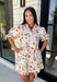 Bring a touch of color to your fall wardrobe with this effortlessly charming botanical dress. Featuring a neutral backdrop with a vibrant floral print, this feminine dress is perfect for everything from brunch dates to fall festivals. The adjustable drawstring waist creates a flattering silhouette, while the collared v-neckline and partial button placket add a timeless touch. Finished with sweet tie details at the sleeves, side pockets, and a fully lined design.