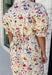 Bring a touch of color to your fall wardrobe with this effortlessly charming botanical dress. Featuring a neutral backdrop with a vibrant floral print, this feminine dress is perfect for everything from brunch dates to fall festivals. The adjustable drawstring waist creates a flattering silhouette, while the collared v-neckline and partial button placket add a timeless touch. Finished with sweet tie details at the sleeves, side pockets, and a fully lined design.