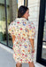 Bring a touch of color to your fall wardrobe with this effortlessly charming botanical dress. Featuring a neutral backdrop with a vibrant floral print, this feminine dress is perfect for everything from brunch dates to fall festivals. The adjustable drawstring waist creates a flattering silhouette, while the collared v-neckline and partial button placket add a timeless touch. Finished with sweet tie details at the sleeves, side pockets, and a fully lined design.