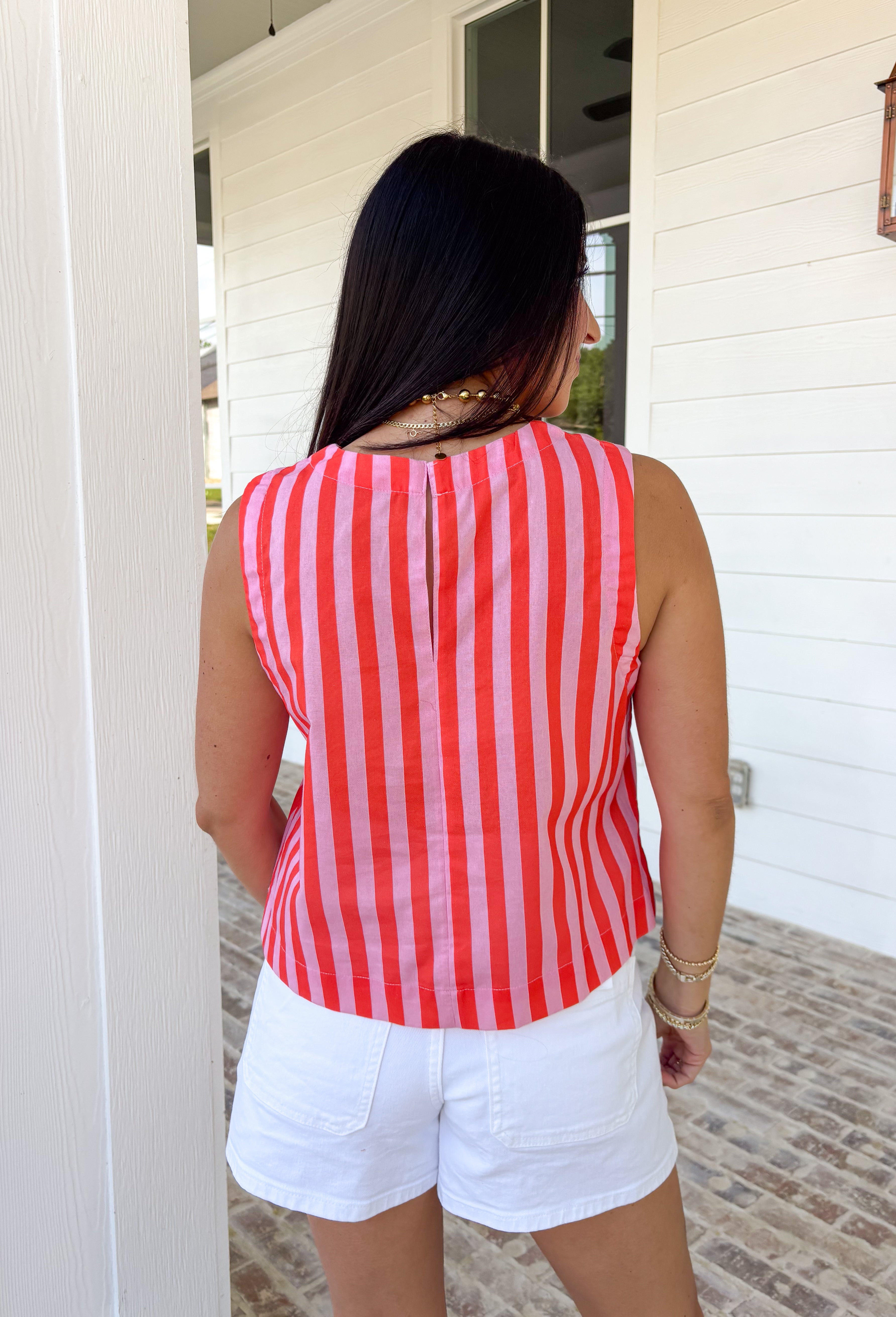 Easy, breezy, and made for sunny days—this red and pink striped tank is the kind of spring staple you’ll reach for on repeat. It’s lightweight, comfy, and effortlessly cute with a classic stripe that never goes out of style. The keyhole closure in the back adds a fun little detail that makes it feel extra special while still keeping it totally everyday-wearable.
