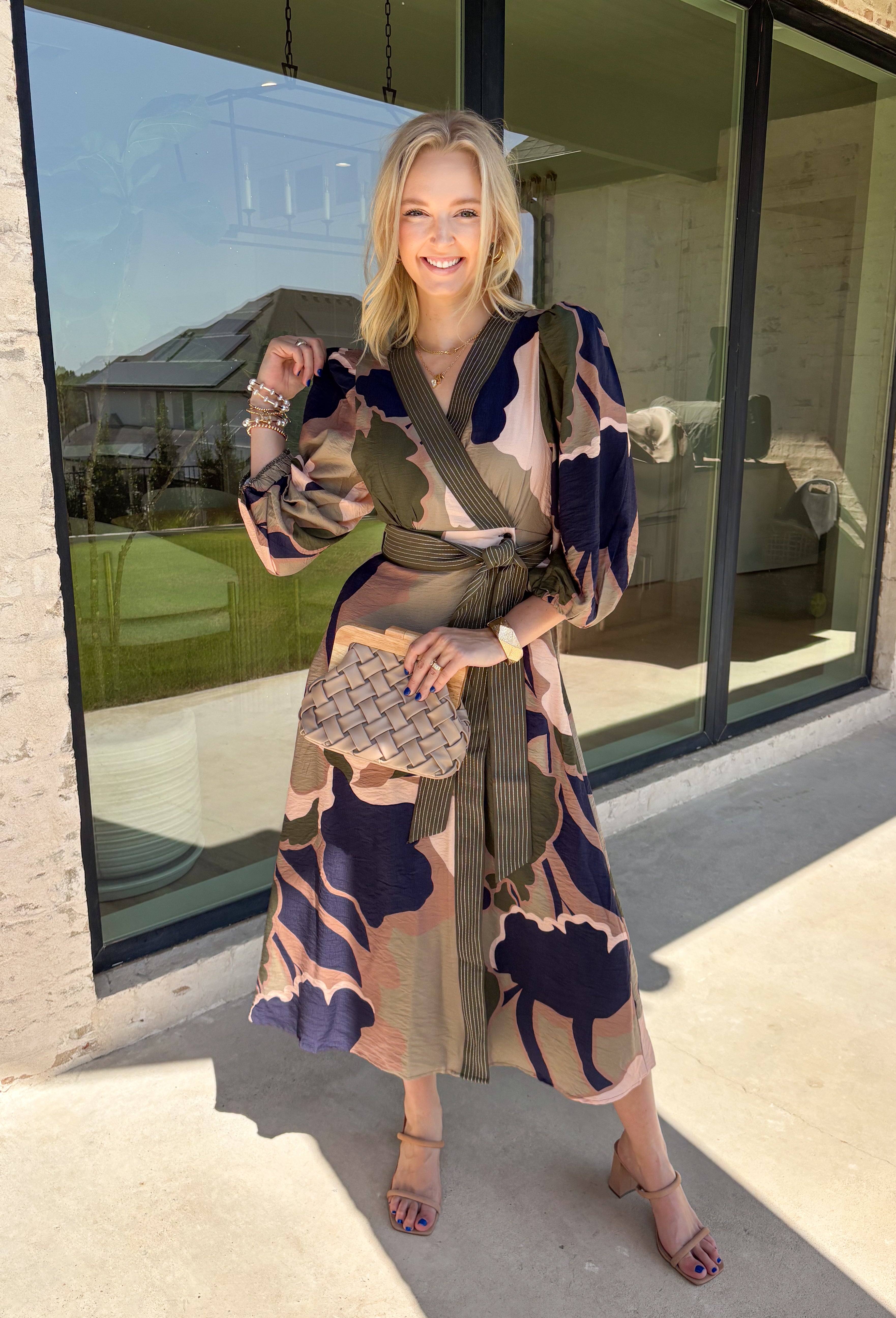 All the colors we love for fall come together in this printed midi dress from Entro. A mix of olive, navy, and tan creates a rich seasonal palette that feels right at home at autumn gatherings, family photos, and weekend plans. The v-neckline is accented with contrast stripe trim for a fun mix of prints, while long balloon sleeves add beautiful shape to the silhouette. A coordinating self-tie belt lets you define the waist, and convenient side pockets make it even easier to wear. 