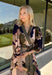 All the colors we love for fall come together in this printed midi dress from Entro. A mix of olive, navy, and tan creates a rich seasonal palette that feels right at home at autumn gatherings, family photos, and weekend plans. The v-neckline is accented with contrast stripe trim for a fun mix of prints, while long balloon sleeves add beautiful shape to the silhouette. A coordinating self-tie belt lets you define the waist, and convenient side pockets make it even easier to wear. 