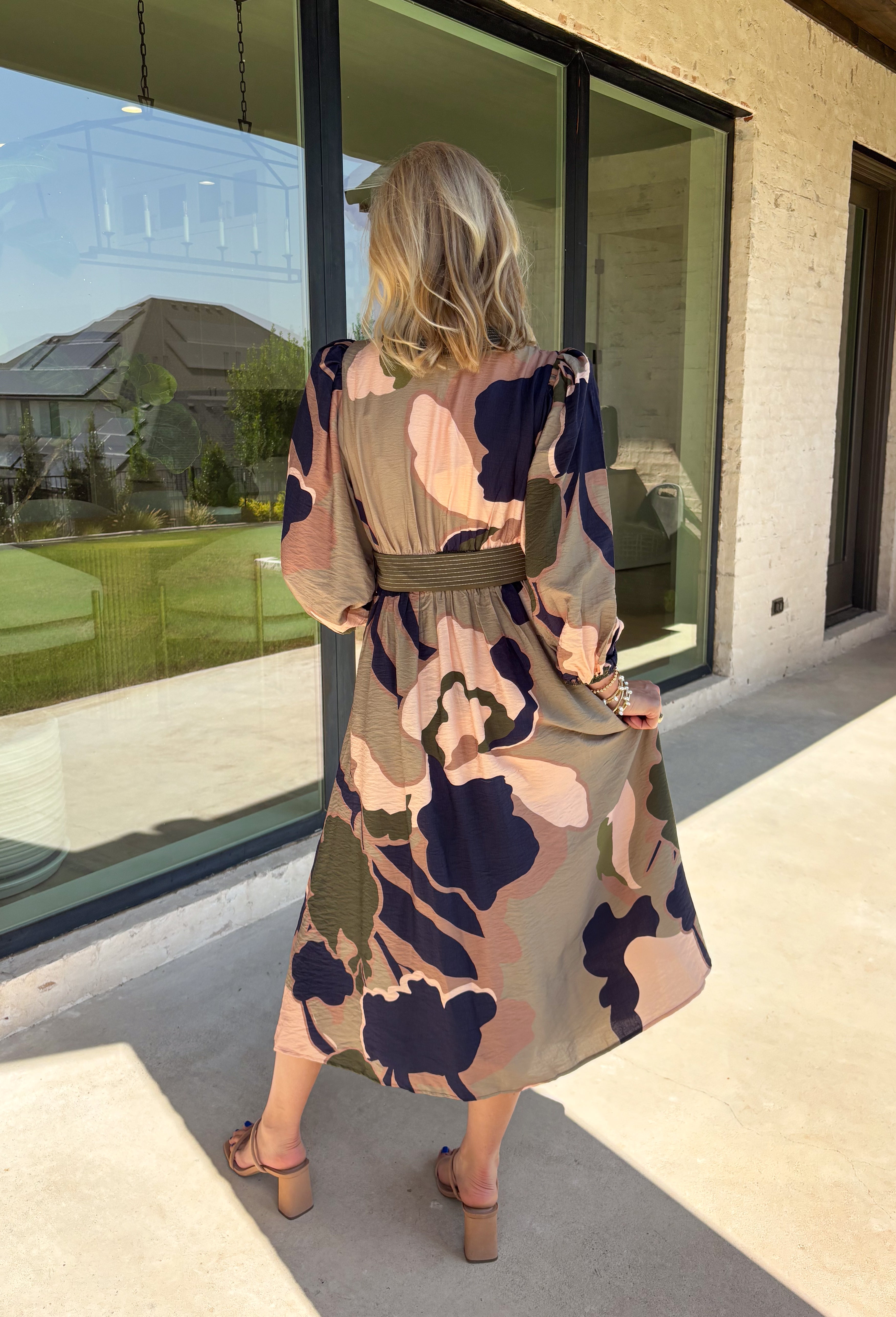 All the colors we love for fall come together in this printed midi dress from Entro. A mix of olive, navy, and tan creates a rich seasonal palette that feels right at home at autumn gatherings, family photos, and weekend plans. The v-neckline is accented with contrast stripe trim for a fun mix of prints, while long balloon sleeves add beautiful shape to the silhouette. A coordinating self-tie belt lets you define the waist, and convenient side pockets make it even easier to wear. 