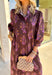 Earthy tones meet feminine charm in this beautiful botanical print midi dress by Entro. Designed with ¾ sleeves and a soft ruffle trim along the collar and front placket, it’s full of subtle details that make it feel special. The button-front design and side pockets bring functionality, while the brown base with purple and dark yellow florals gives it that perfect fall color palette. Fully lined and made from breathable cotton, it’s comfortable enough for all-day wear while keeping your look effortlessly po