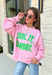 Add a little western attitude to your cozy season! This playful pink mock neck sweatshirt features a bold "Cool It, Cowboy" graphic in textured green striped lettering for the perfect mix of retro charm and everyday comfort. The ribbed neckline, cuffs, and hem give this fleece-lined pullover an elevated finish, making it a standout piece you'll love wearing on crisp fall days.