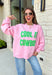 Add a little western attitude to your cozy season! This playful pink mock neck sweatshirt features a bold "Cool It, Cowboy" graphic in textured green striped lettering for the perfect mix of retro charm and everyday comfort. The ribbed neckline, cuffs, and hem give this fleece-lined pullover an elevated finish, making it a standout piece you'll love wearing on crisp fall days.